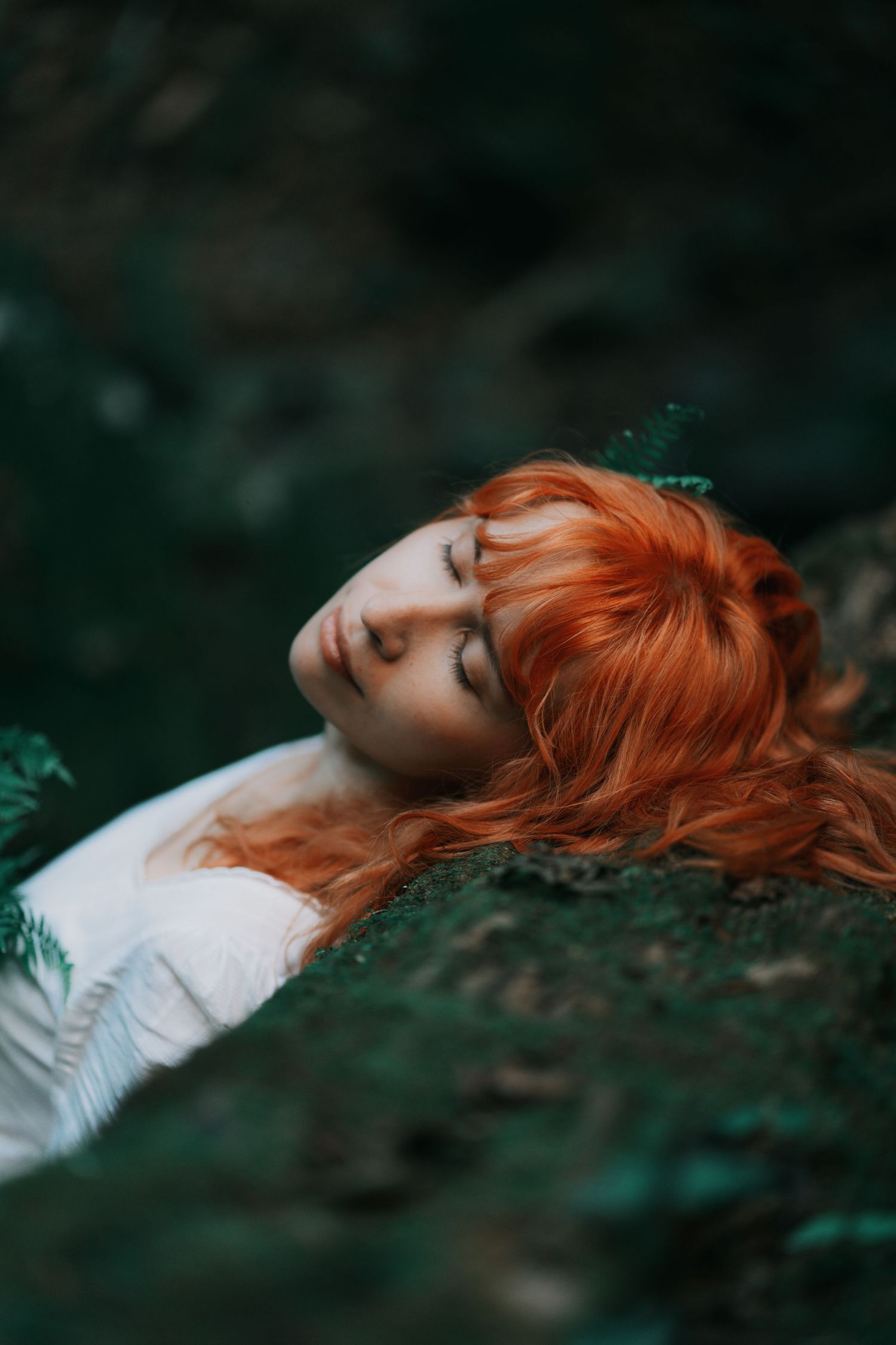 Portrait of a red-haired girl in a forest