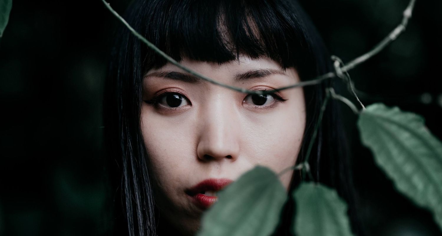 Close-up portrait of a beautiful Asian girl with red lipstick