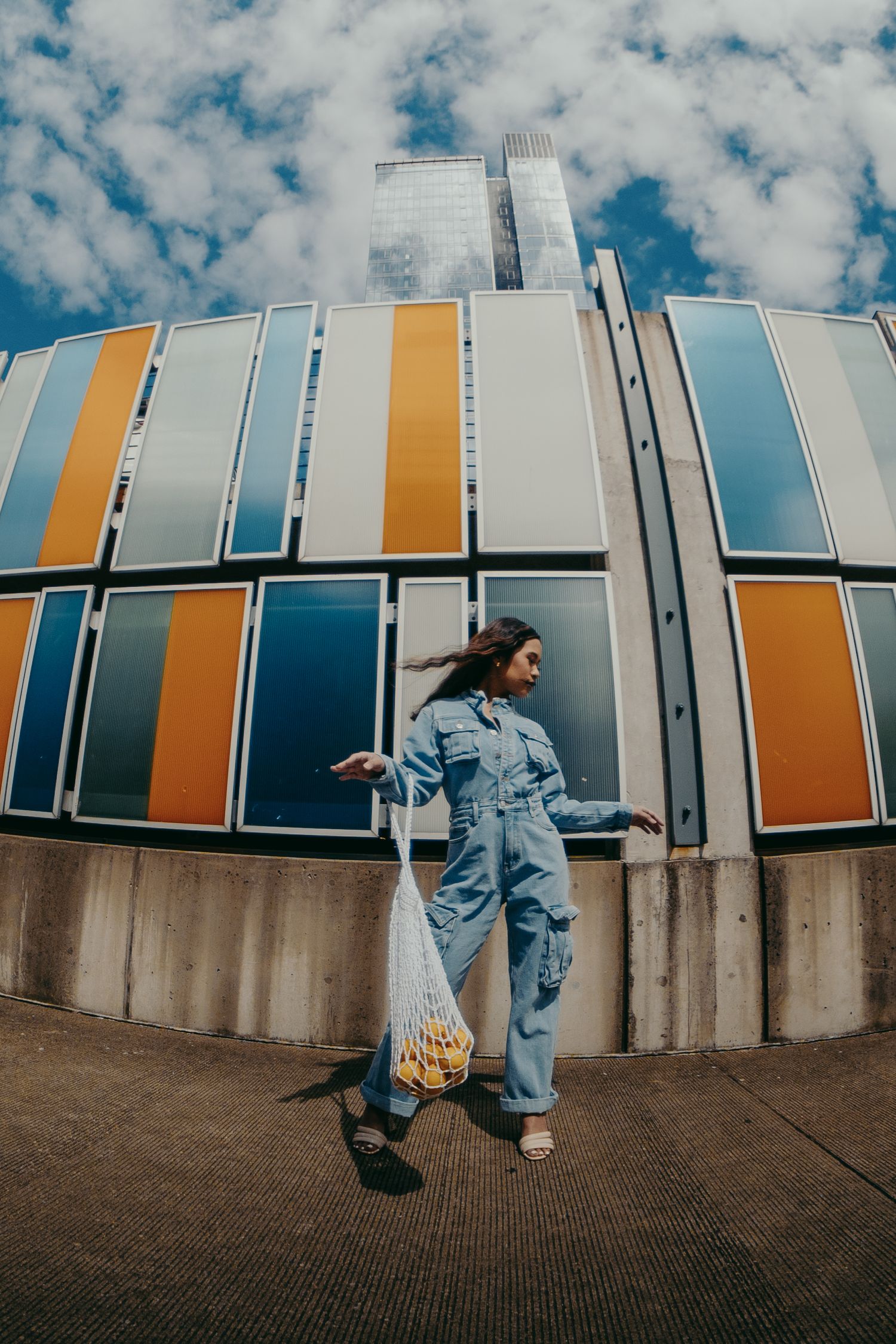 Fish-eye portrait of a girl against a colorful wall