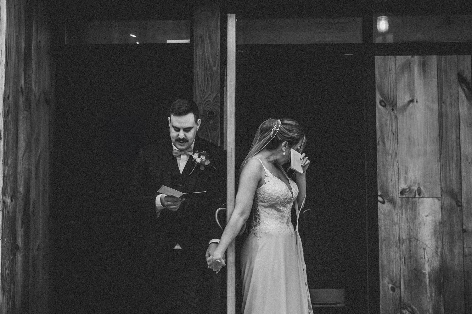 Artistic black and white wedding sequence in rustic wooden venue interior.