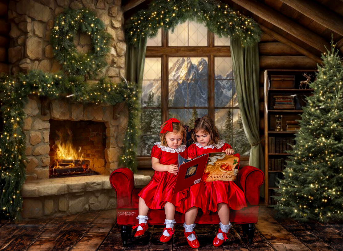 Two girls in red dresses read a book by a fireplace in a cozy Christmas cabin with mountain views.