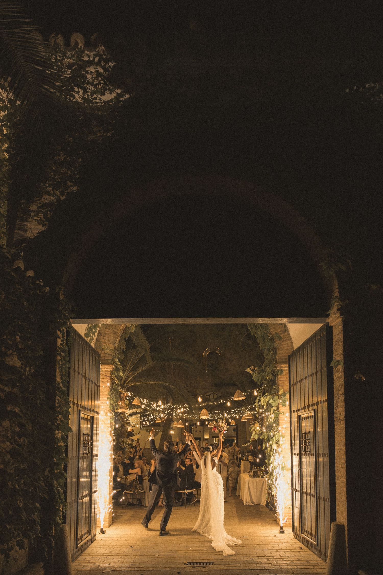 Illuminated wedding ceremony space with elegant archway and ambient lighting.