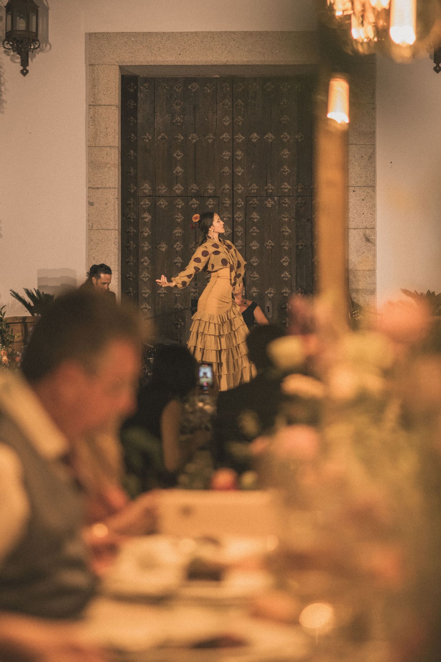Romantic wedding reception setting with warm lighting and elegant table decorations.