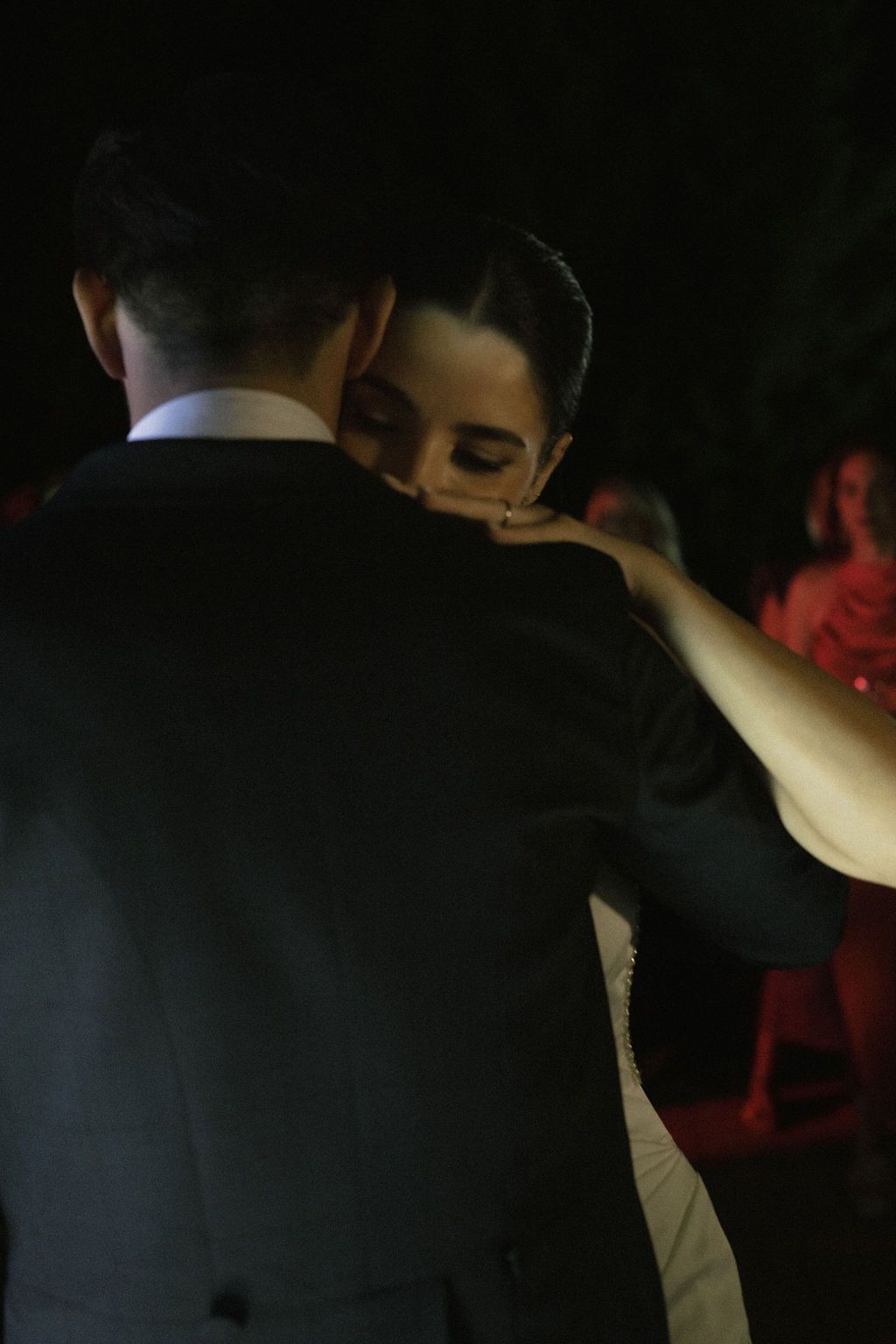 Intimate dance scene in low lighting at an elegant evening event.