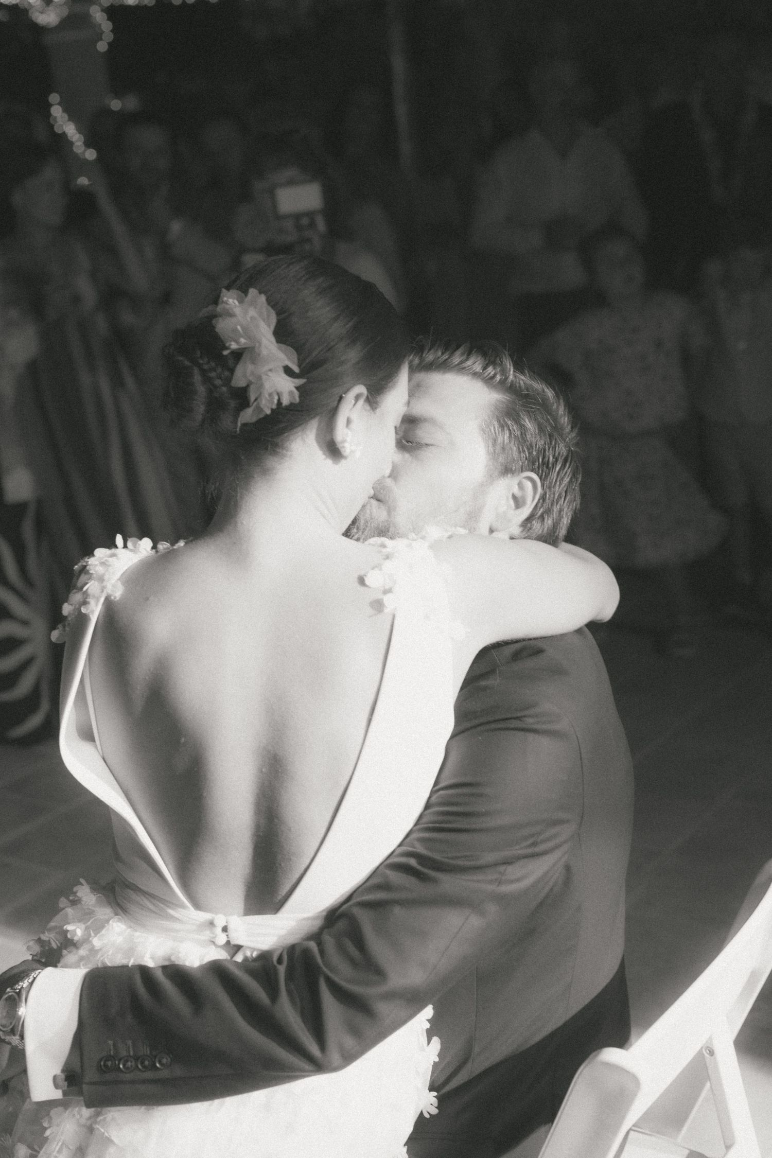 Couple sharing romantic dance moves in black and white at evening reception.