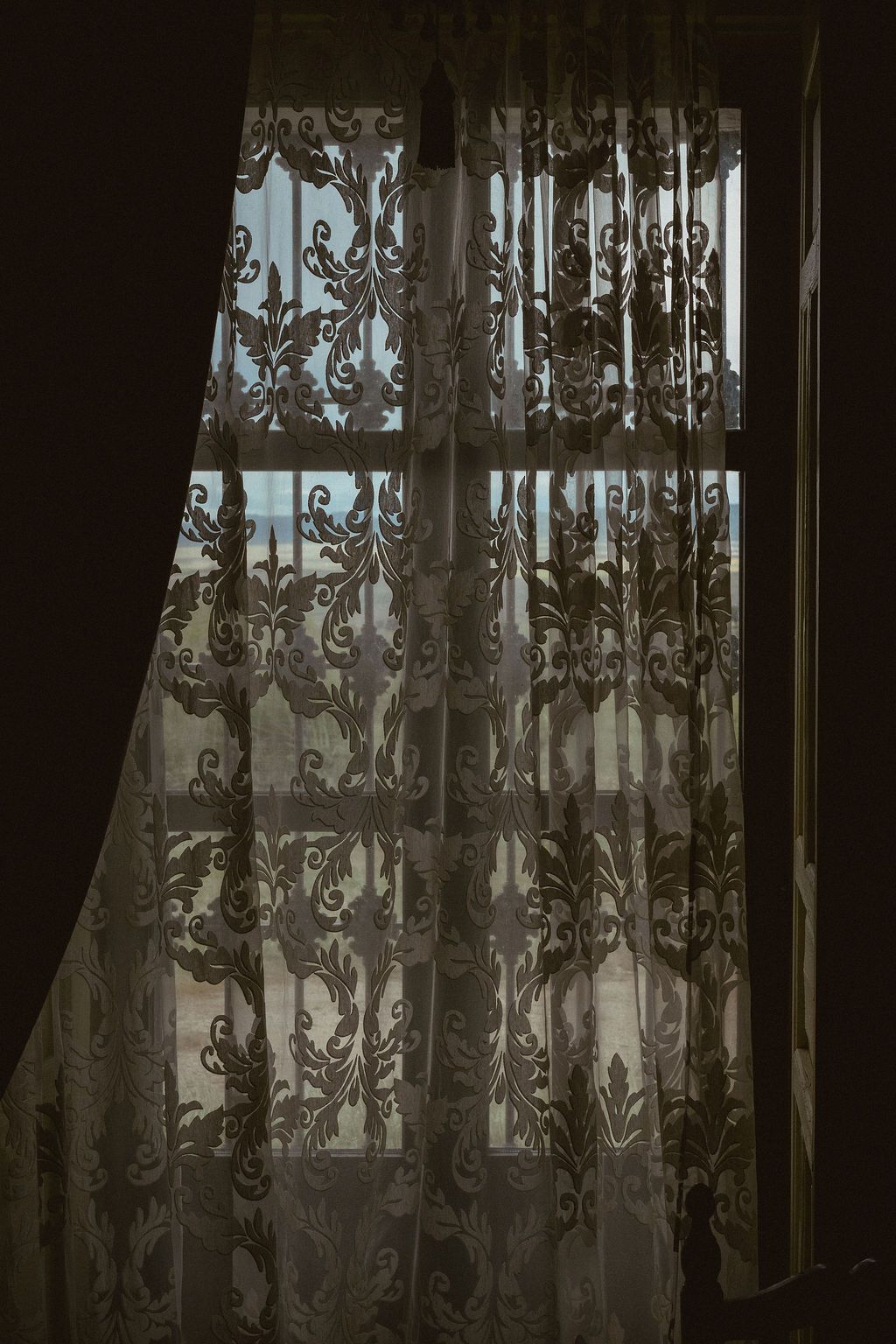 Sunlight filtering through delicate lace curtains creating a romantic atmosphere.