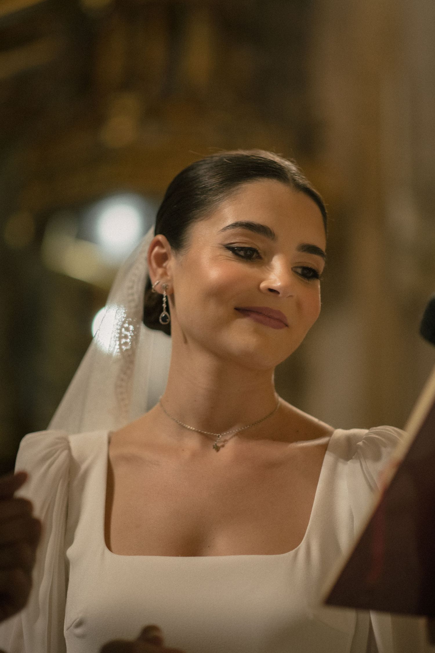 Close-up shots of a bride in a white dress and veil getting ready for her wedding ceremony.
