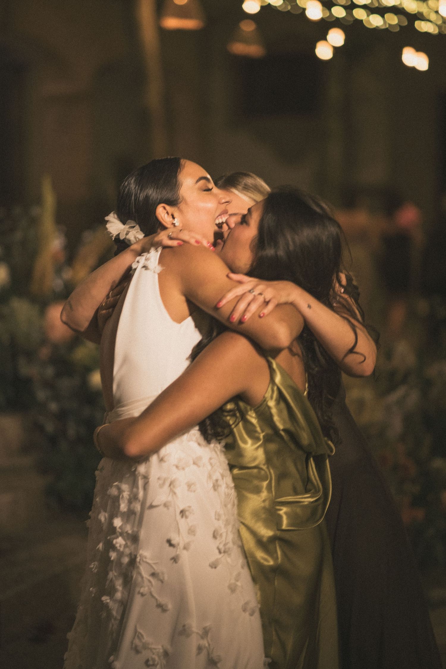 Intimate moment shared between wedding couple under romantic evening lighting.