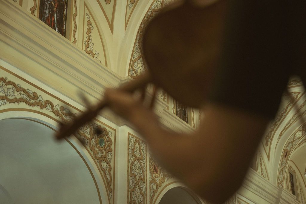 Ornate ceiling with classical architectural details and moldings in warm lighting.