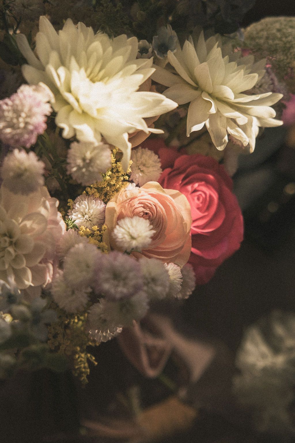 Romantic floral arrangement with white dahlias, pink roses and delicate baby's breath.