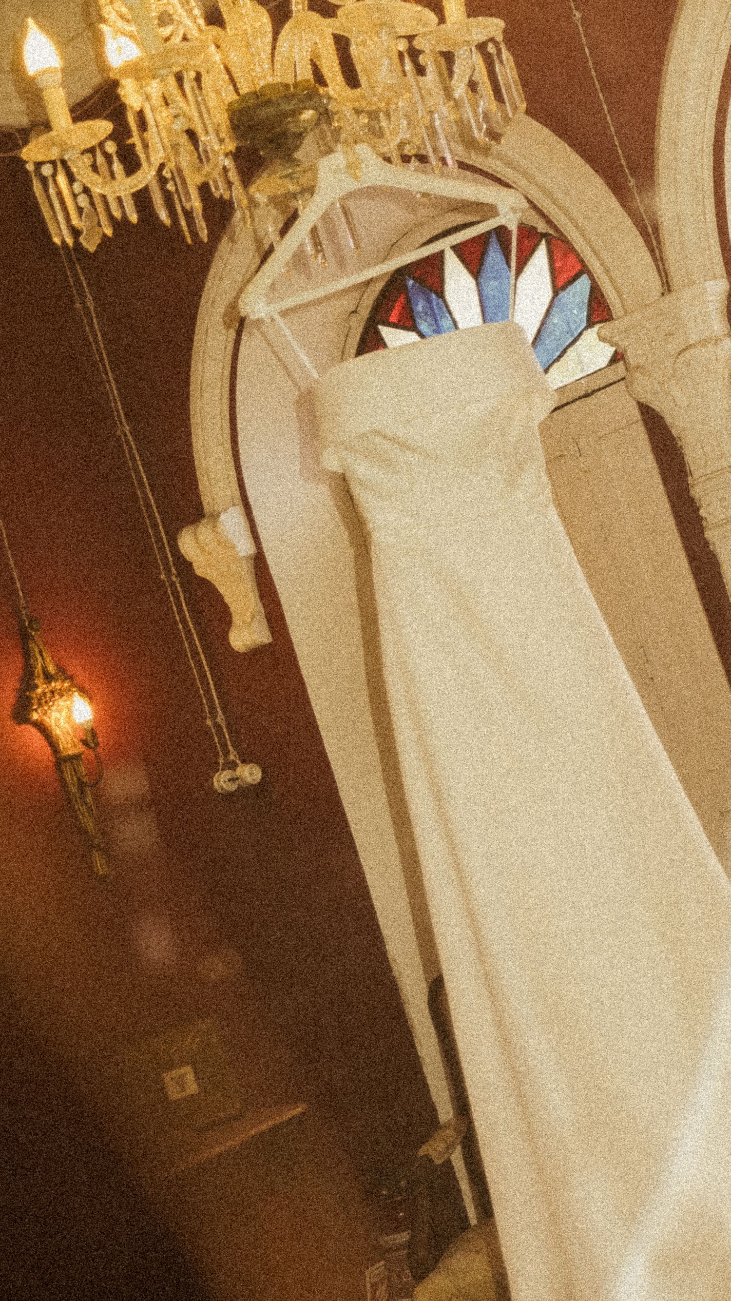 Wedding dress detail showing elegant white fabric and architectural elements.