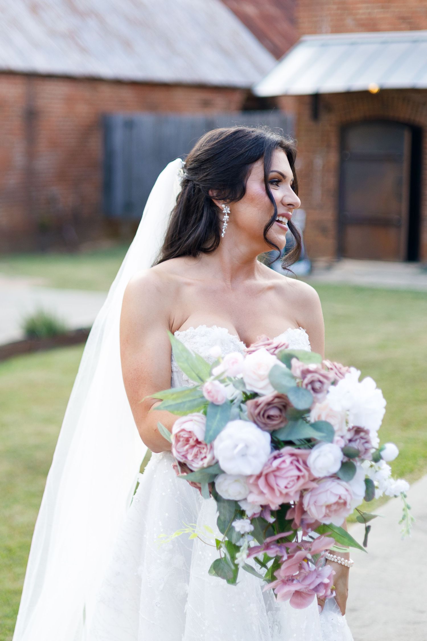 Bridal bouquet features dusty pink and white roses with eucalyptus leaves.