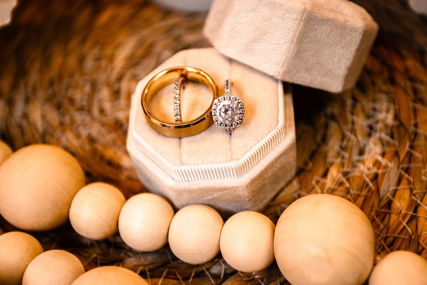 Diamond engagement ring and wedding band in octagonal velvet box with wooden beads.
