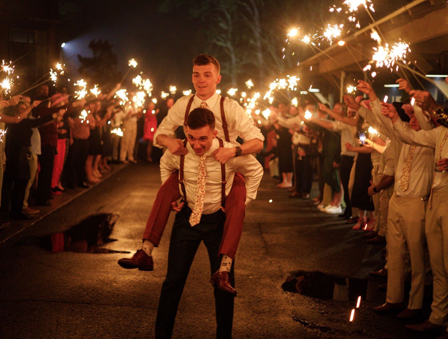 A sparkler exit celebration with guests creating a magical tunnel of light for the newlyweds.