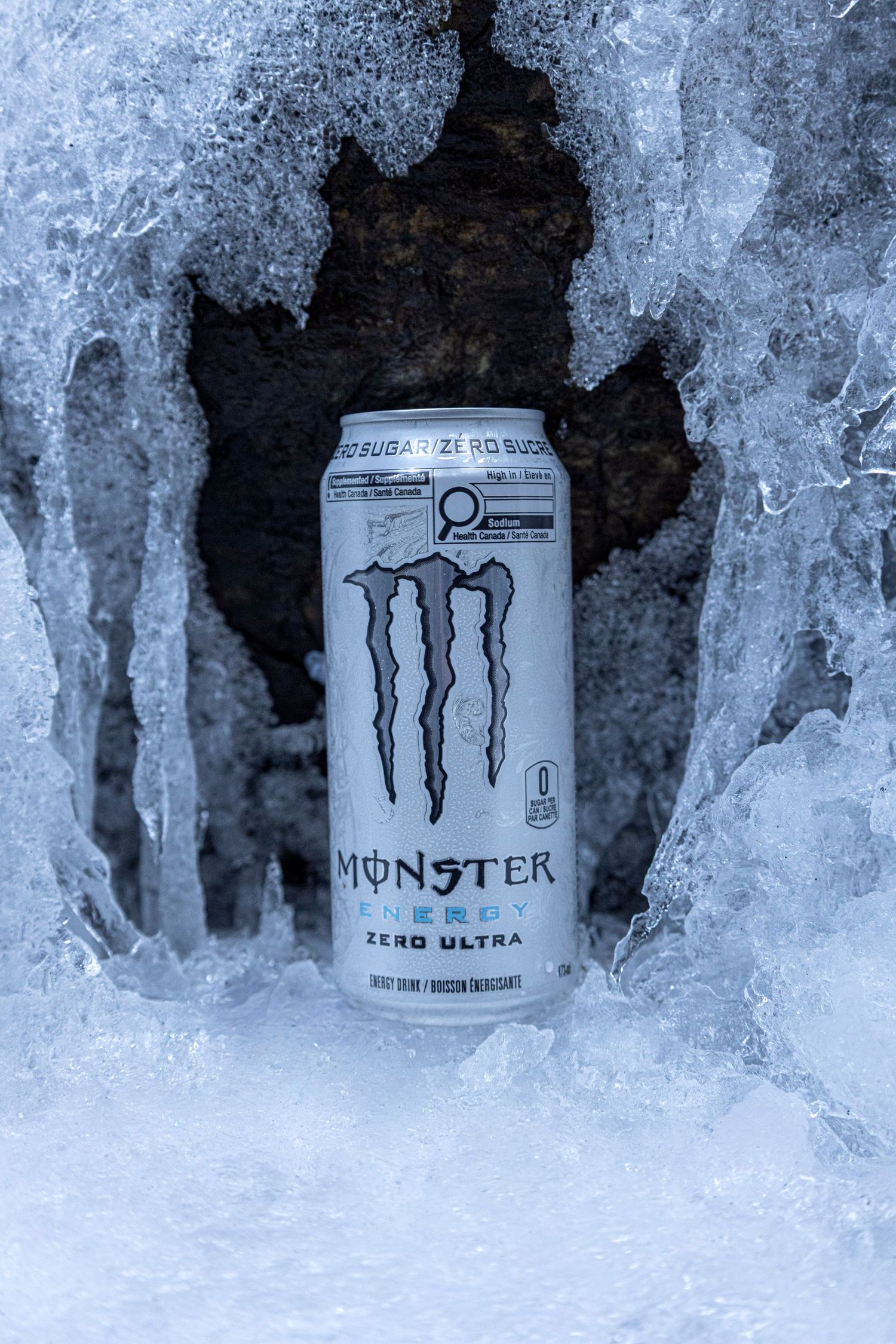 Creative product shot of Monster Zero Ultra can buried in snow for a cool, refreshing effect.