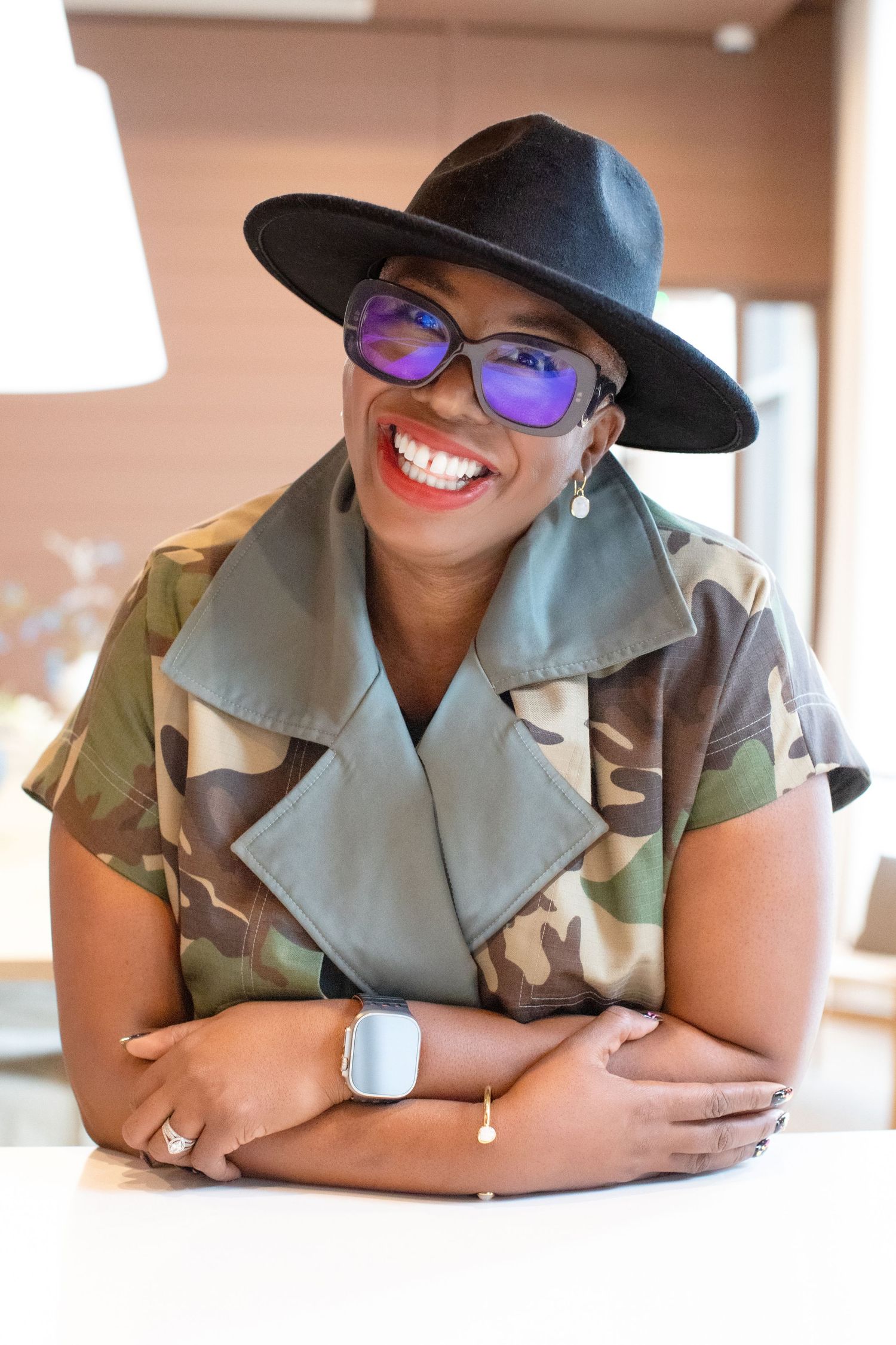 Three stylized portrait photos showing someone in a khaki uniform and black hat smiling and posing.