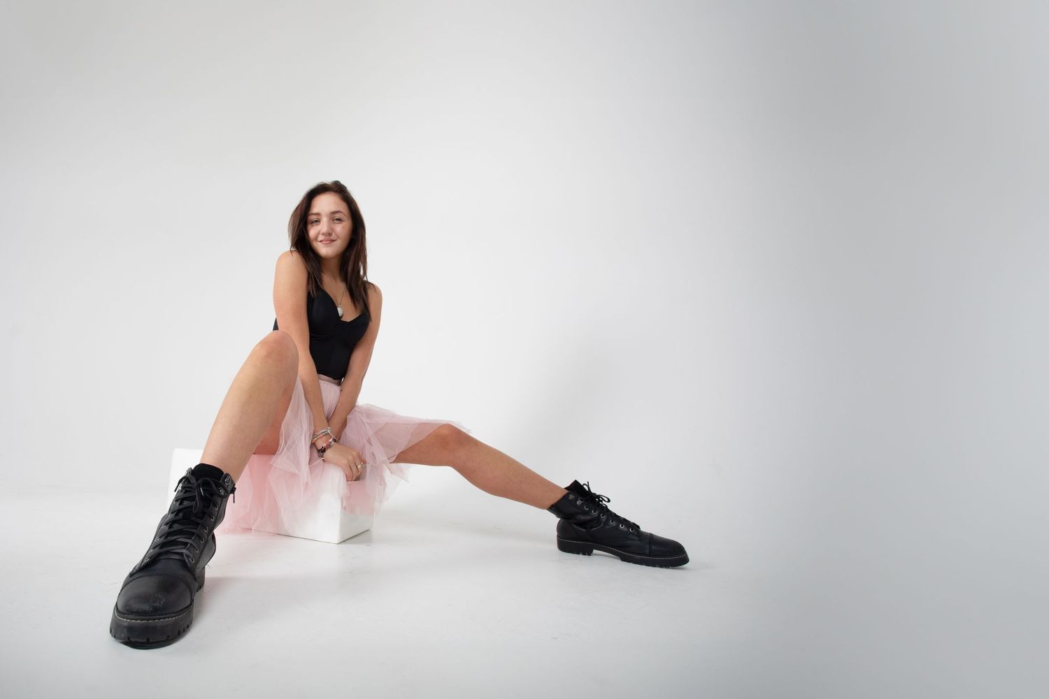 Modern dance movements photographed in a minimalist white studio setting.