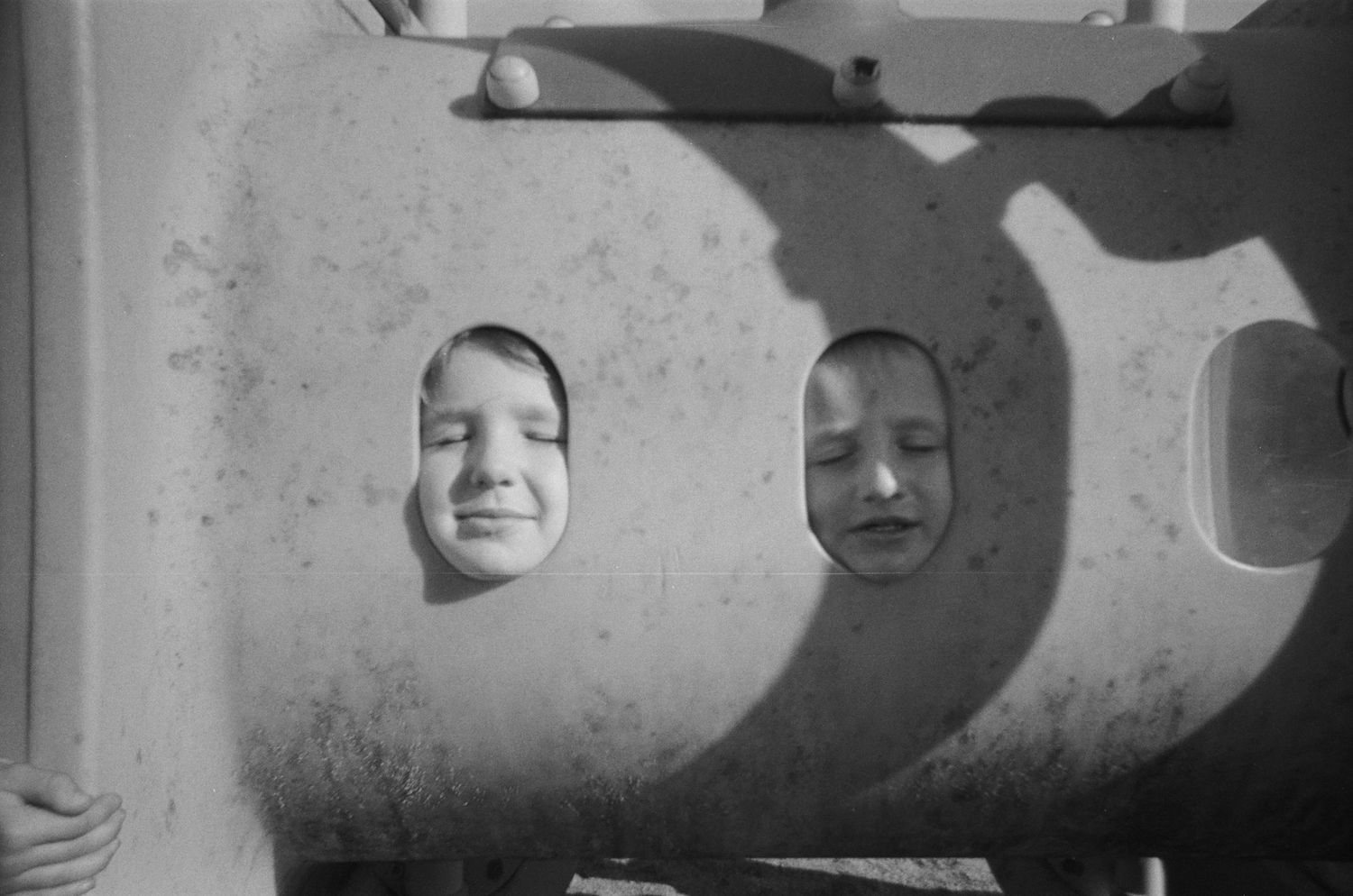 Vintage black and white film strip showing smiling expressions in sequence.