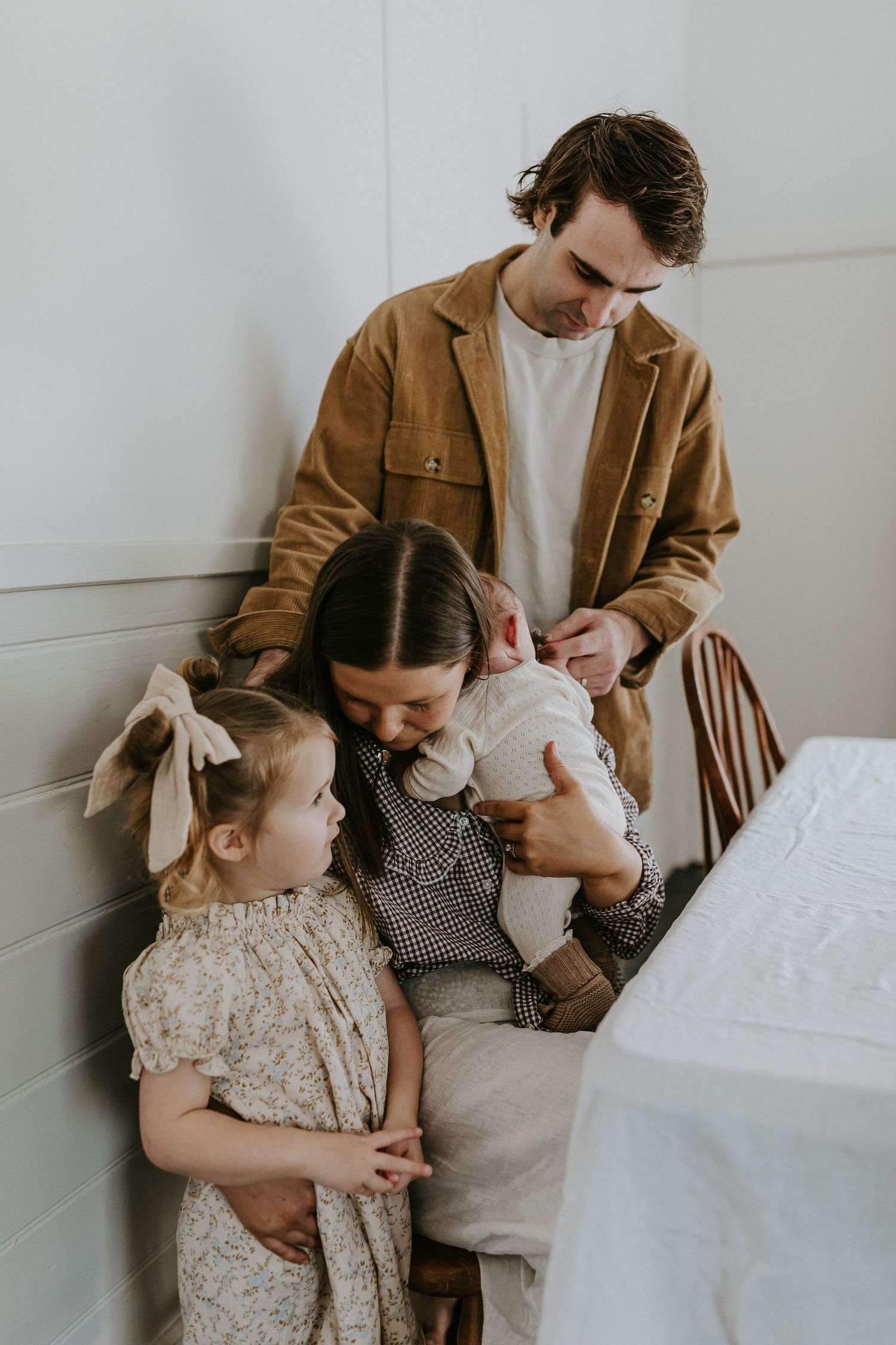 Intimate family moment captured in a series of tender indoor portraits with soft natural lighting.