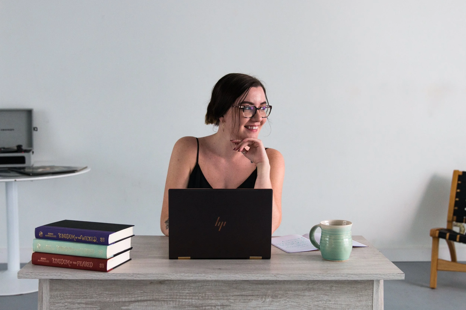 Woman at desk with computer, books and coffee mug. Brand photography RVA, brand photography Richmond, Virginia. Headshot photography RVA.