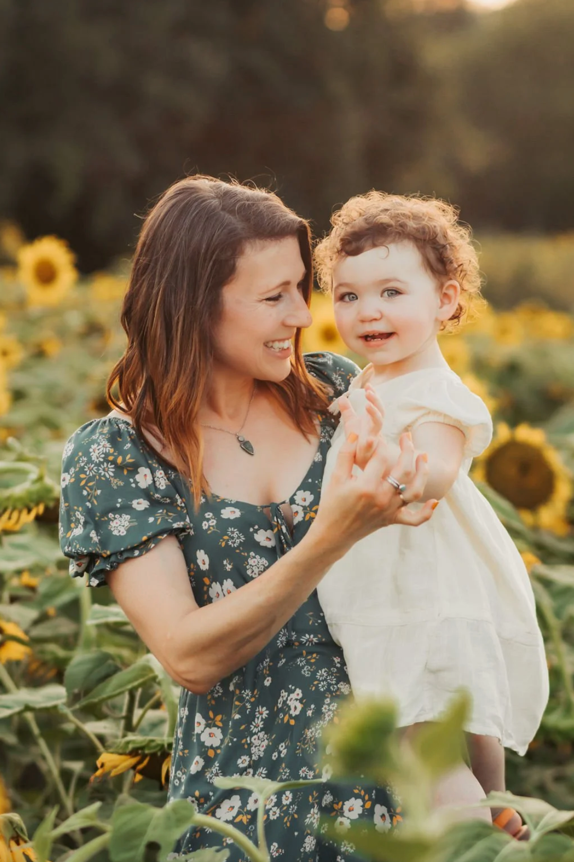 Mom and daughter in sunflower field. Family photography RVA, family photography Richmond, Virginia. Joyful photography.