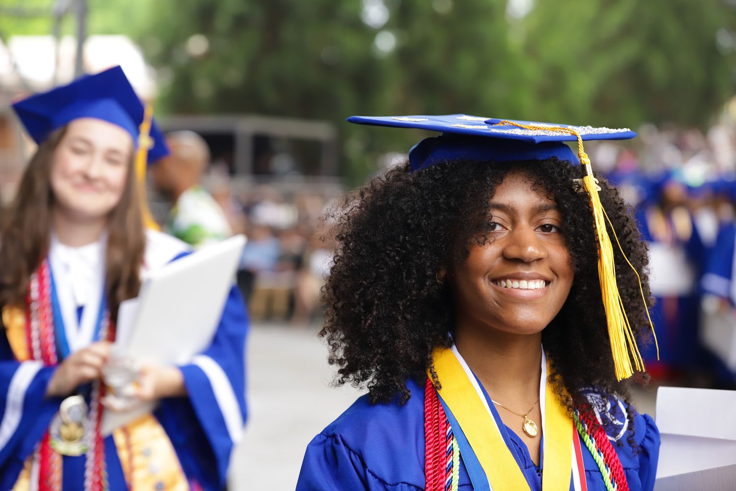 High school graduate celebrating with friends during commencement ceremony in Gwinnett county Georgia captured by Atlanta photographer.