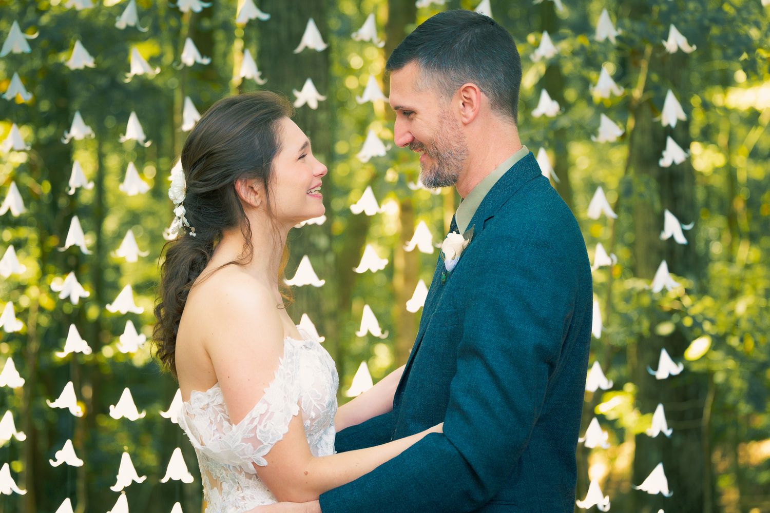Bride and groom exchanging vows at an outdoor Decatur wedding ceremony, captured by Snellville wedding photographer.