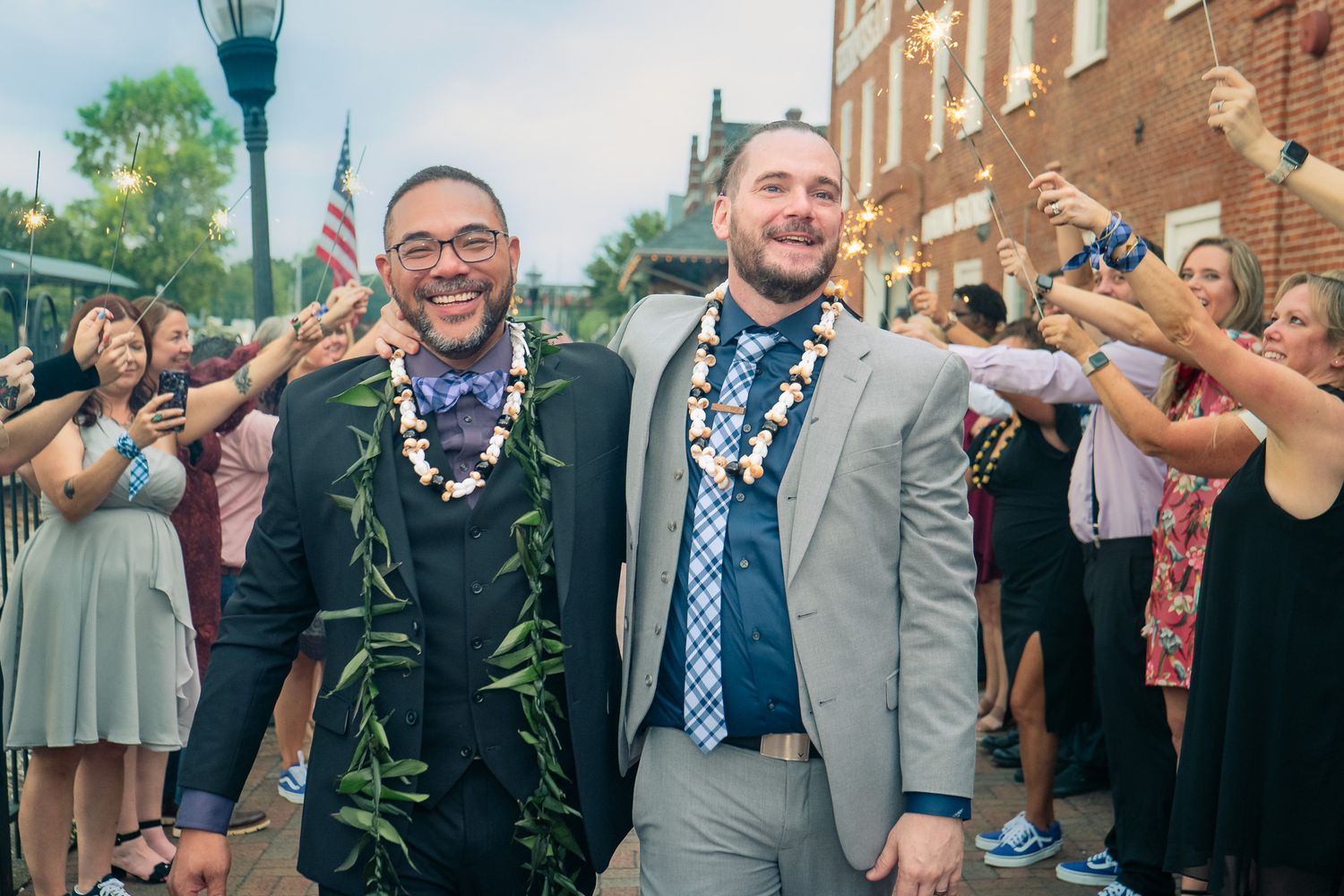 Mixed race same sex groom and groom sharing a joyful moment at a Georgia wedding, photographed by Snellville LGBTQ wedding photographer.