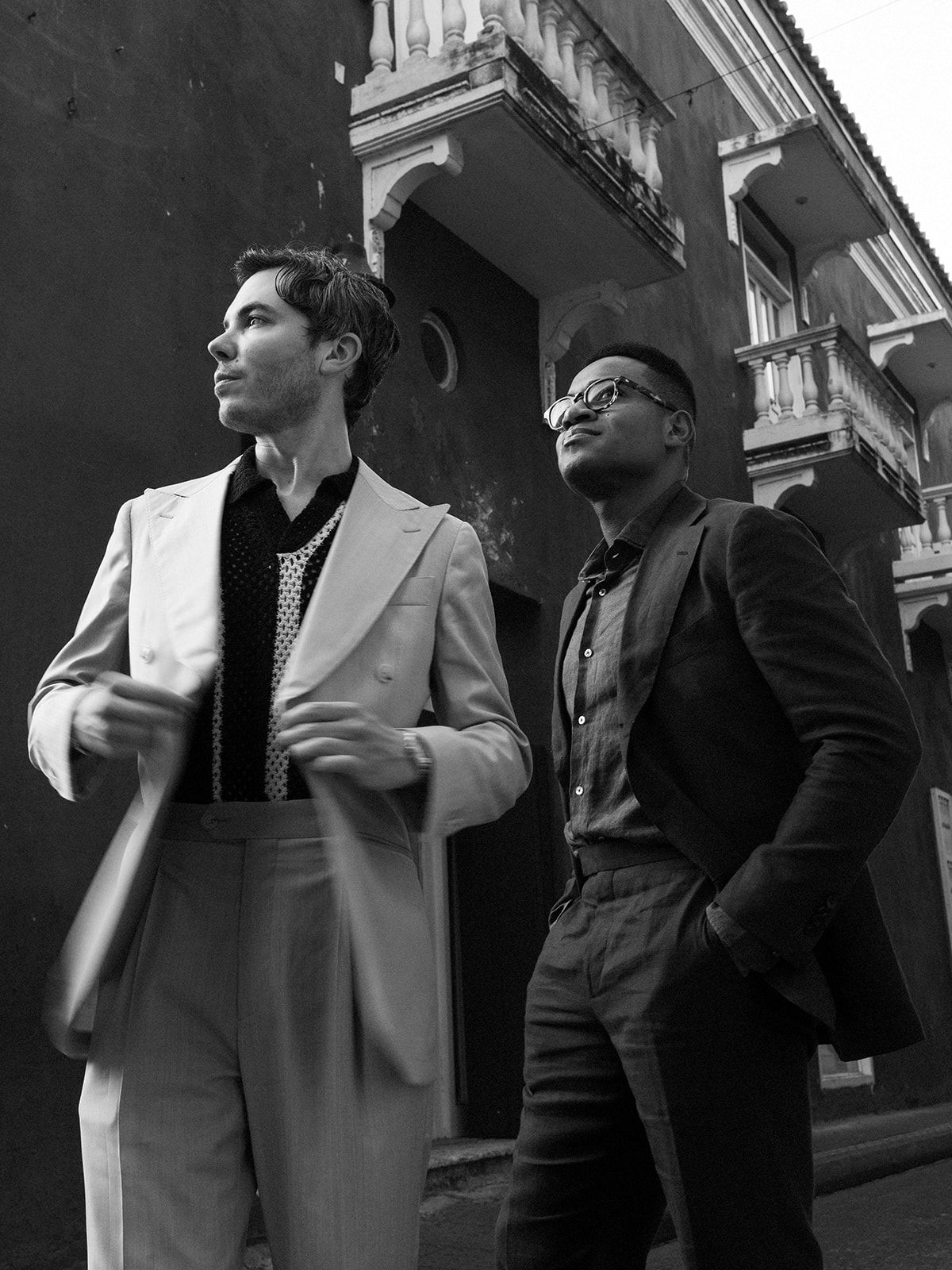 Stylish black and white portrait against colonial architecture.