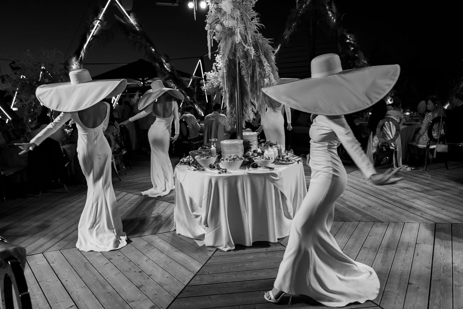 Black and white photos of wedding dance celebrations on an outdoor deck.