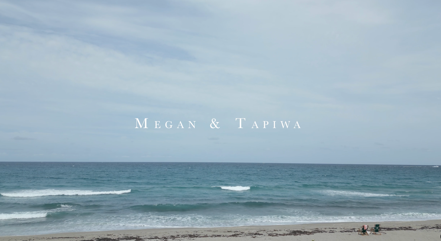 Turquoise ocean waves roll onto a sandy beach under text reading 'Megan & Taylor' against a cloudy sky.