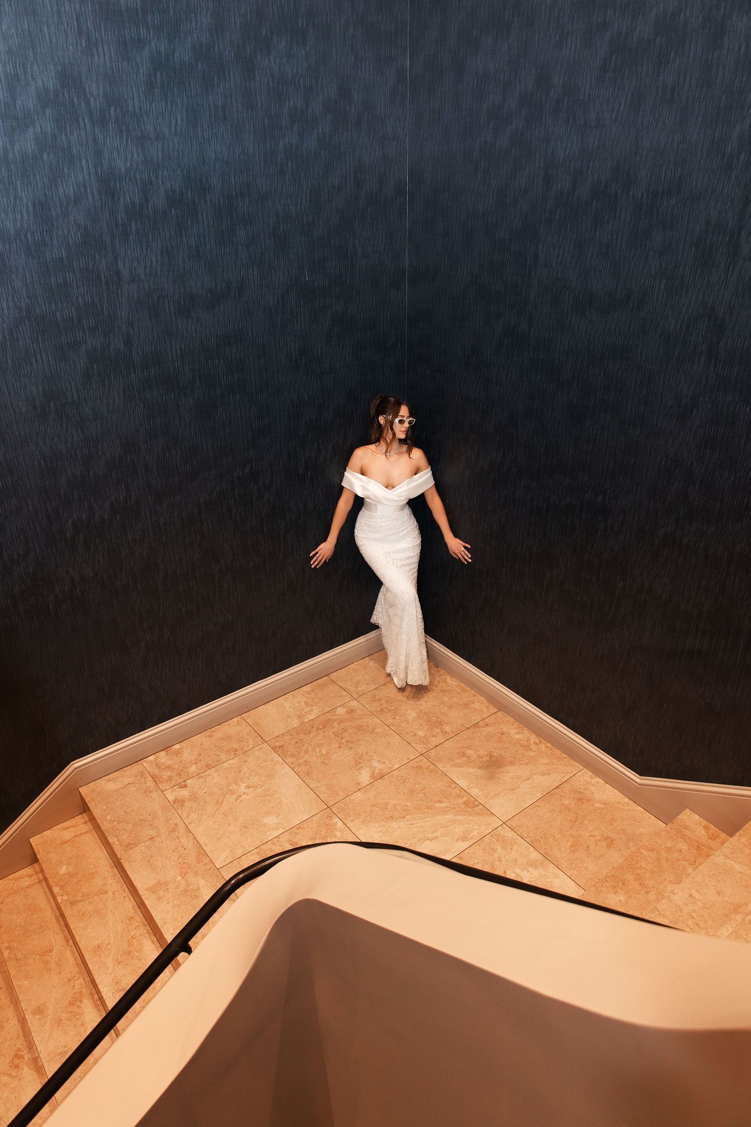A series of artistic photos showing a person in a white dress posing on a geometric wooden platform.