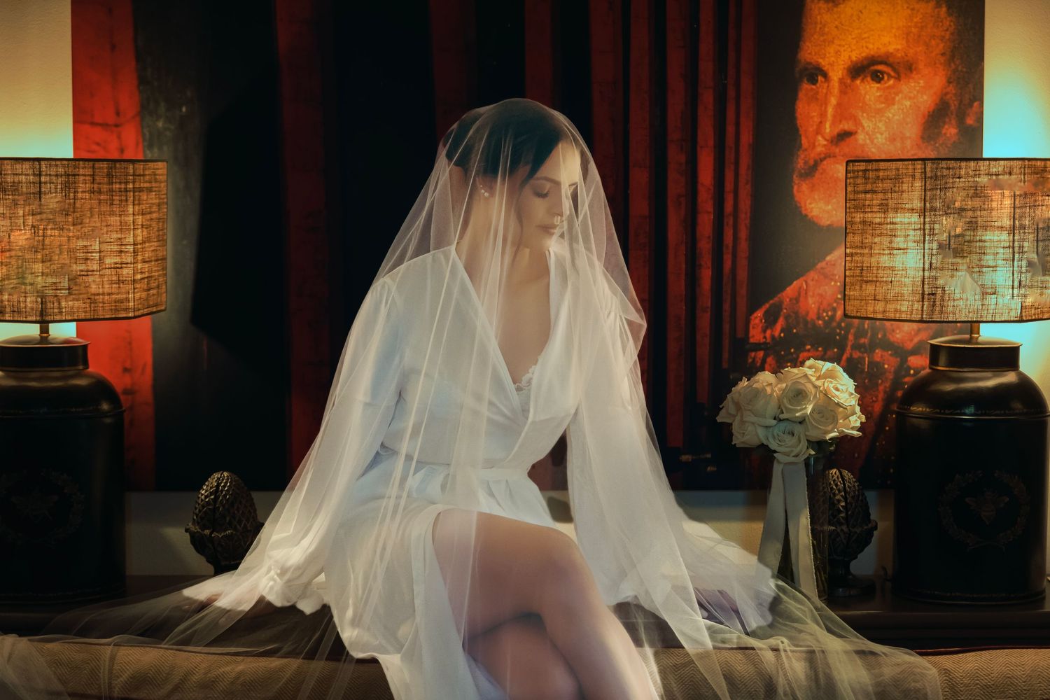Wedding dress captured in warm ambient lighting with artistic shadows and veils.