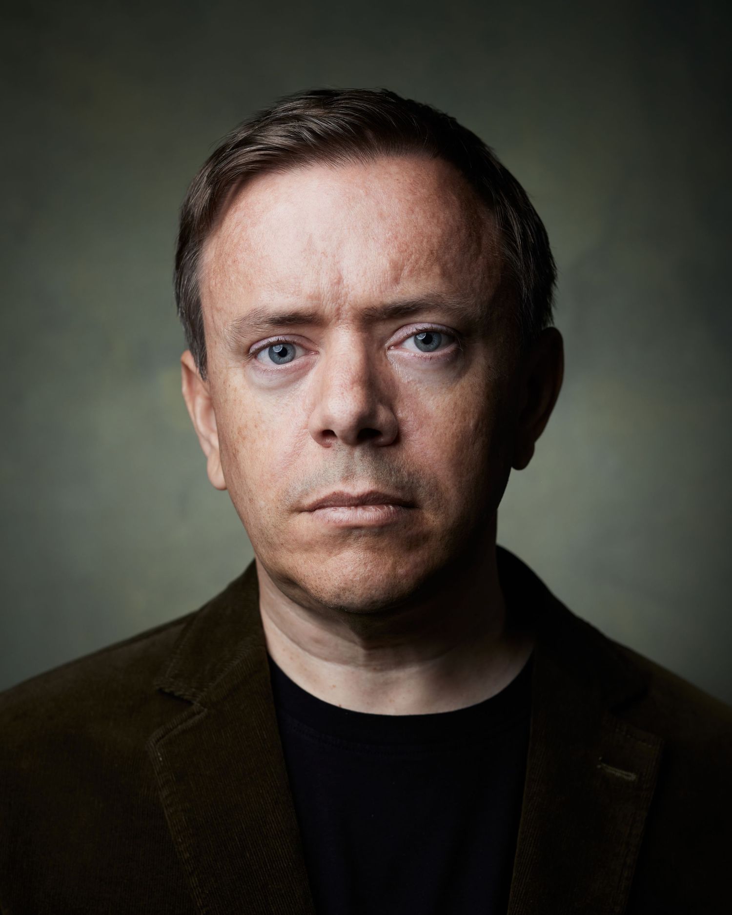 Intense dramatic portrait; male actor with a moody, somber gaze.