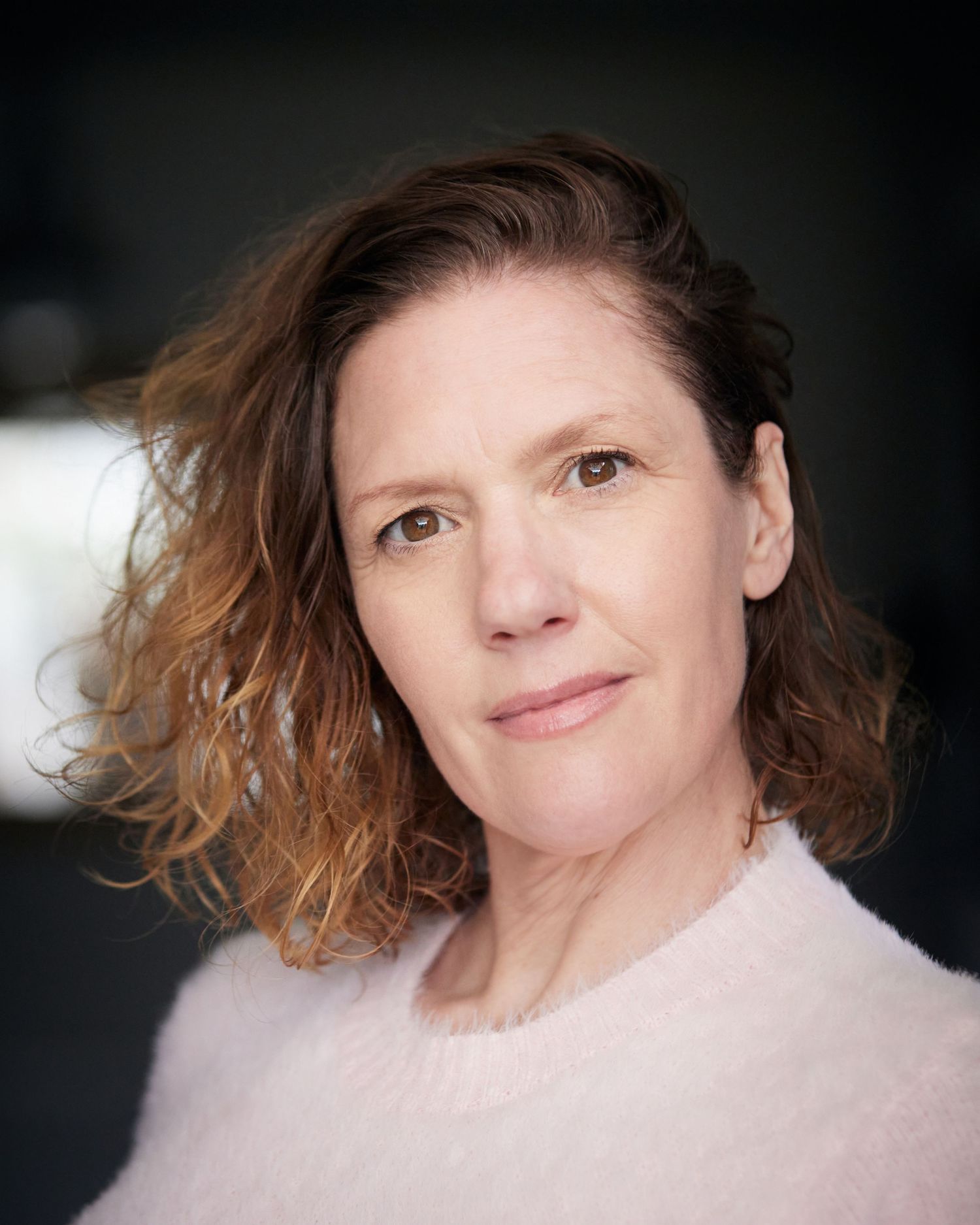 Strict, authoritative portrait; actress with a tough Cardiff look.