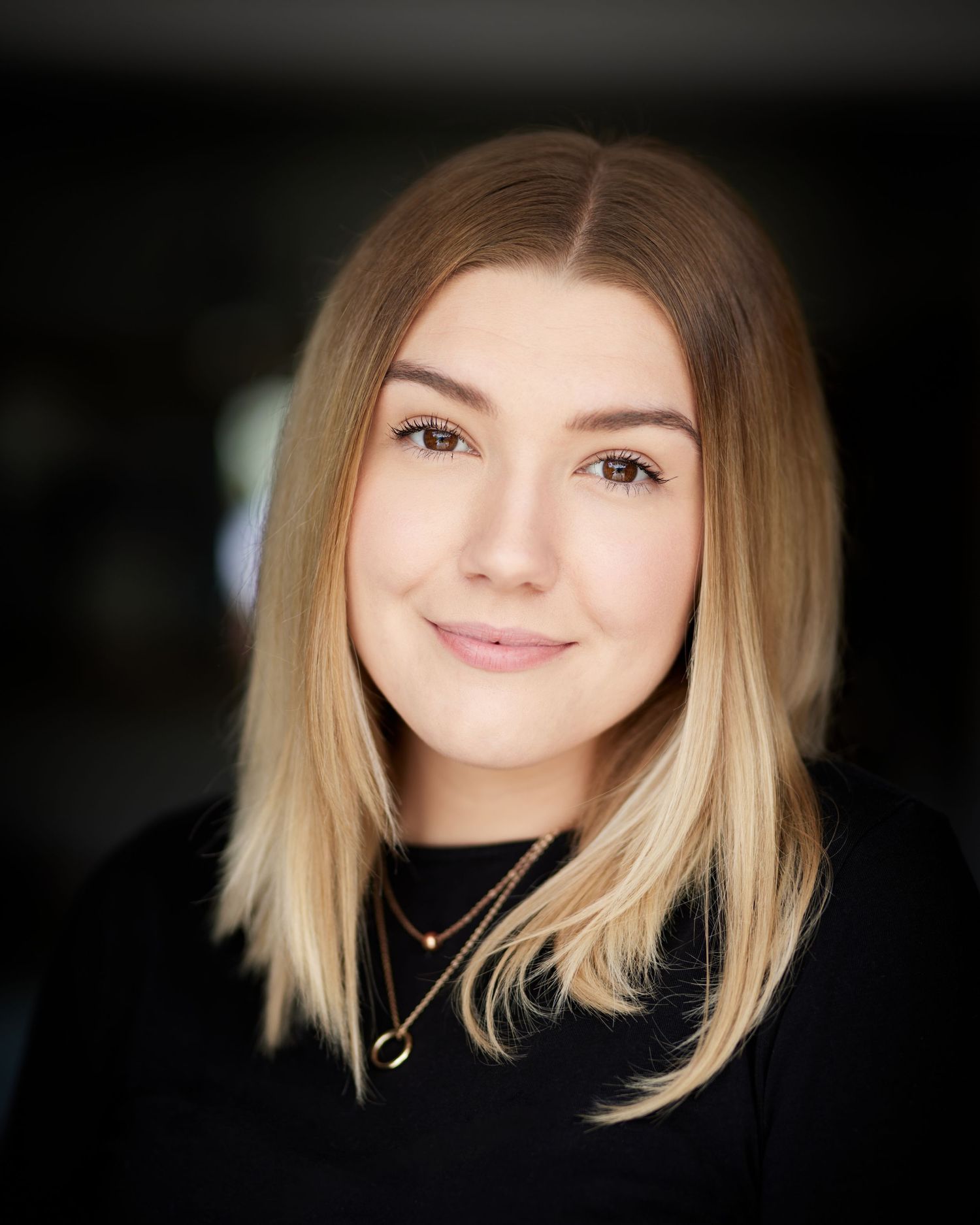 Sincere friendly headshot; actress with an accessible Cardiff natural light look.