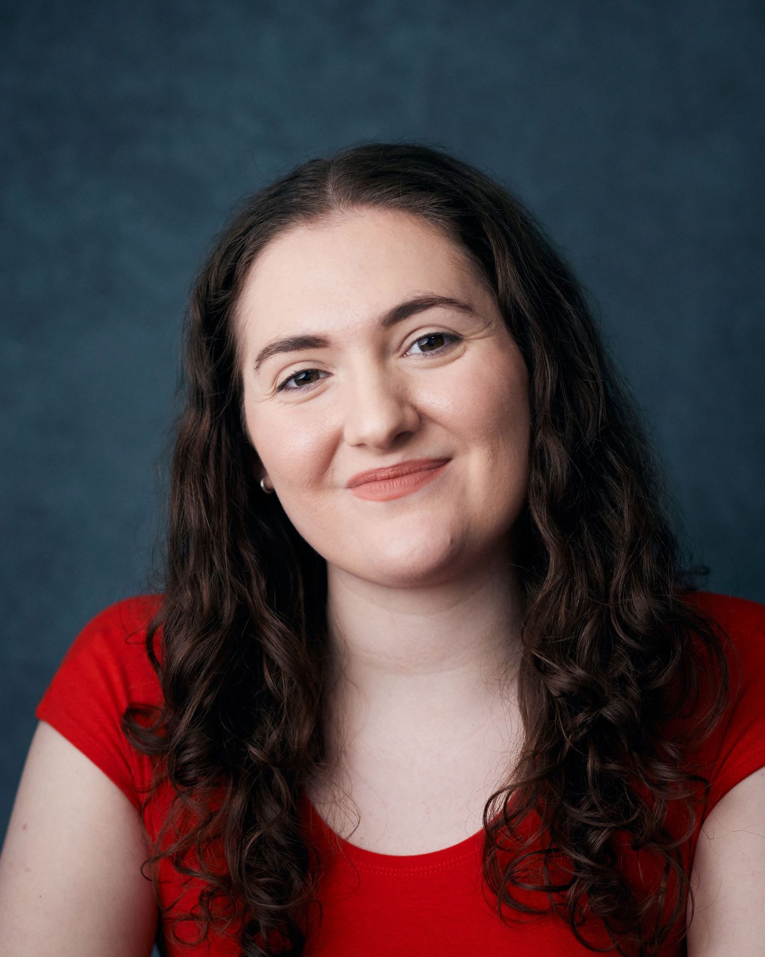 Engaging headshot; female performer with an expressive and charismatic face.