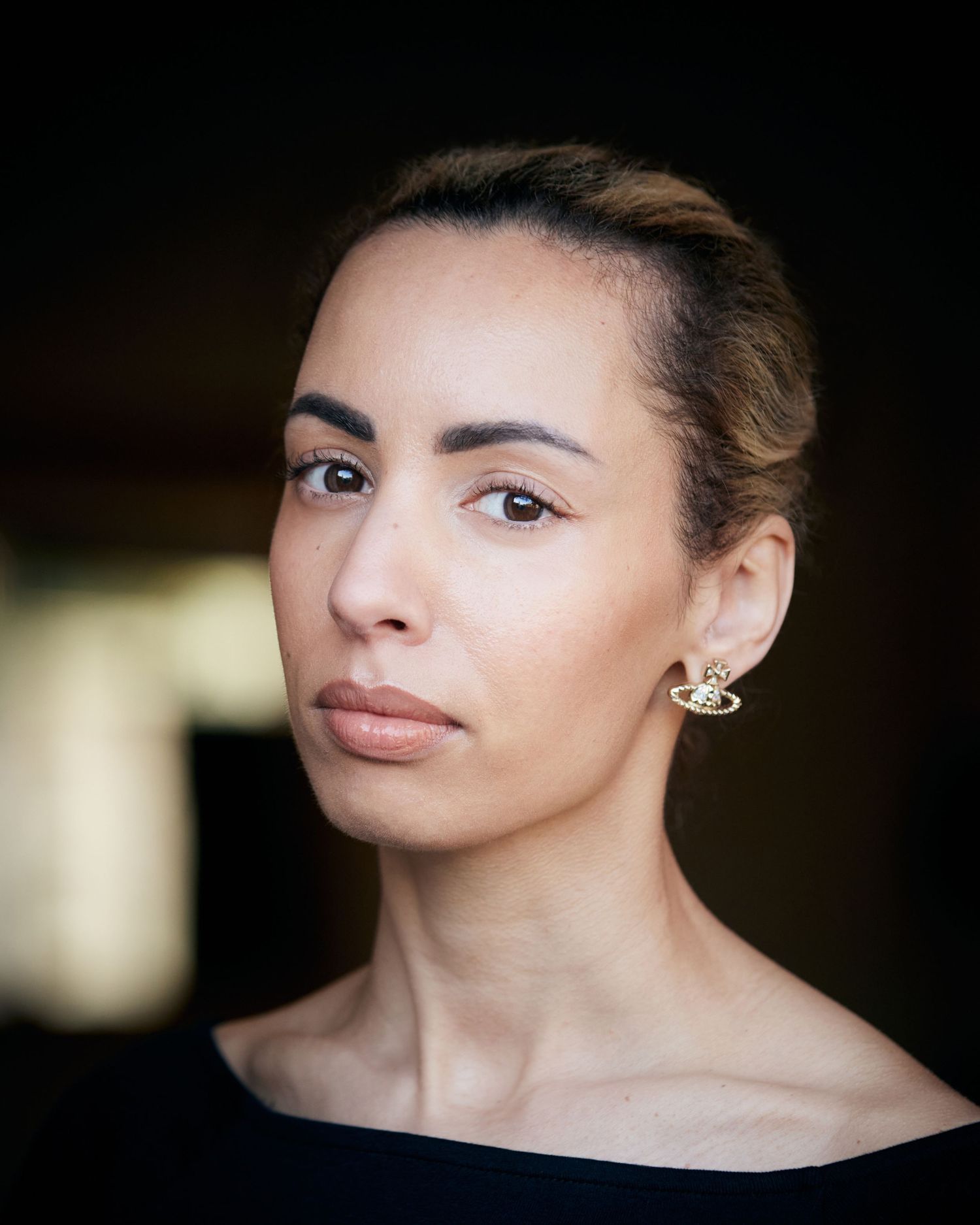 Resilient actor portrait; strong presence in Cardiff with blurred natural background.