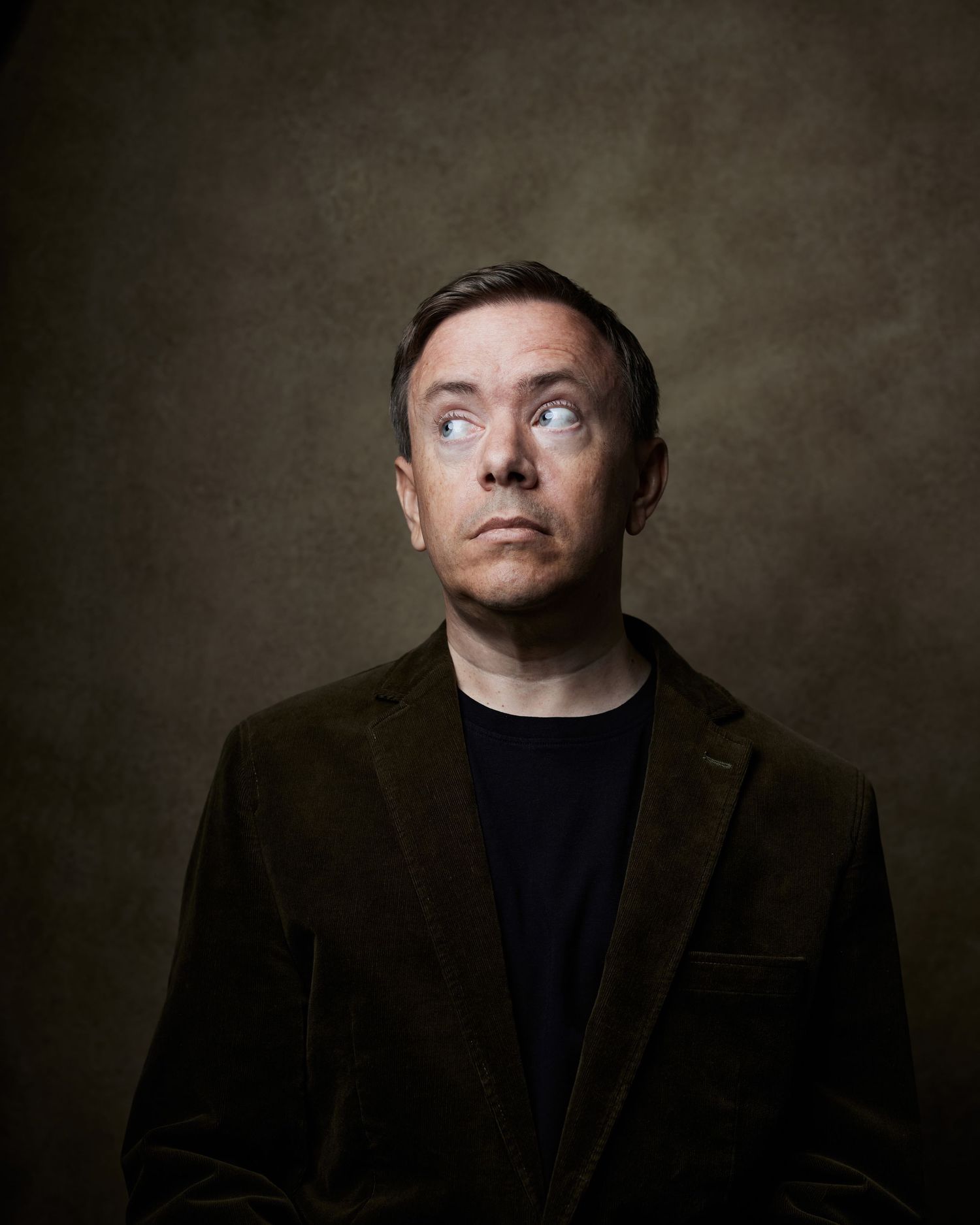 Comedic actor headshot of a man with a surprised expression looking off camera.