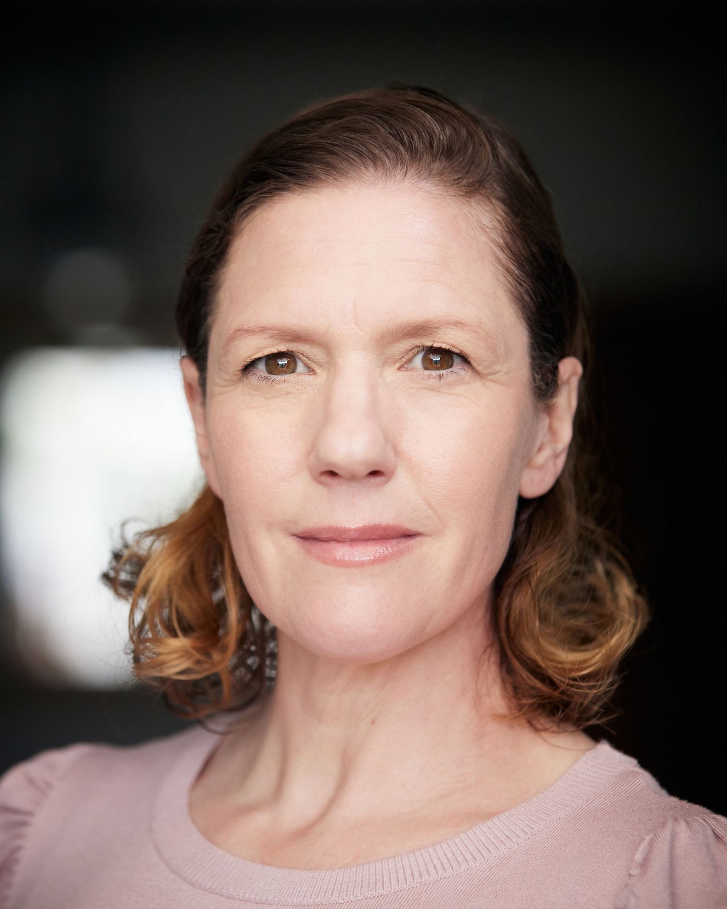 Confident actor portrait; engaging and charismatic in natural light.