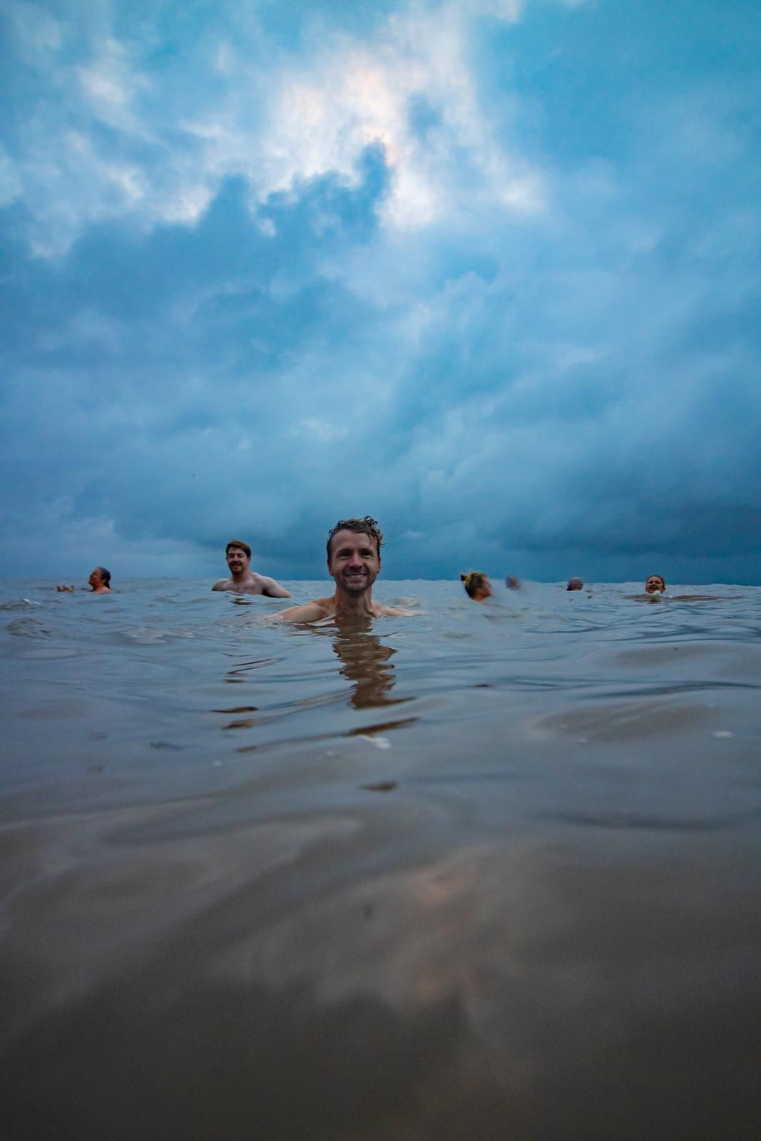Lifestyle portrait of photographer Geraint Todd in the sea.