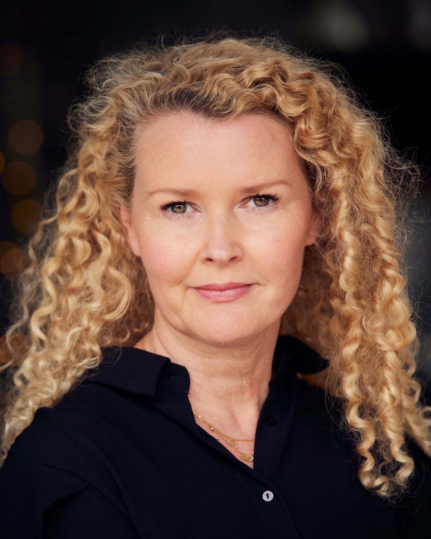 Relatable actor headshot; approachable presence in Cardiff natural daylight.