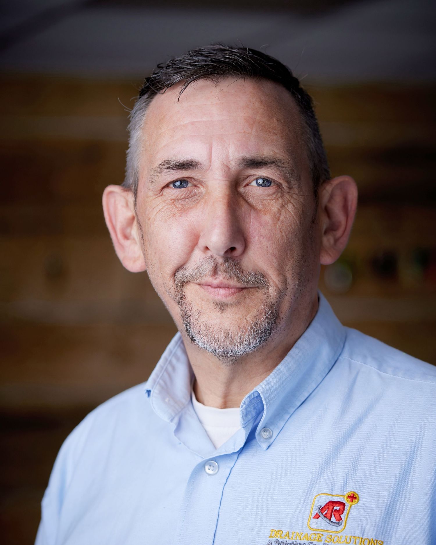 Business portrait photographed against a natural wall by Cardiff headshot photographer Geraint Todd.