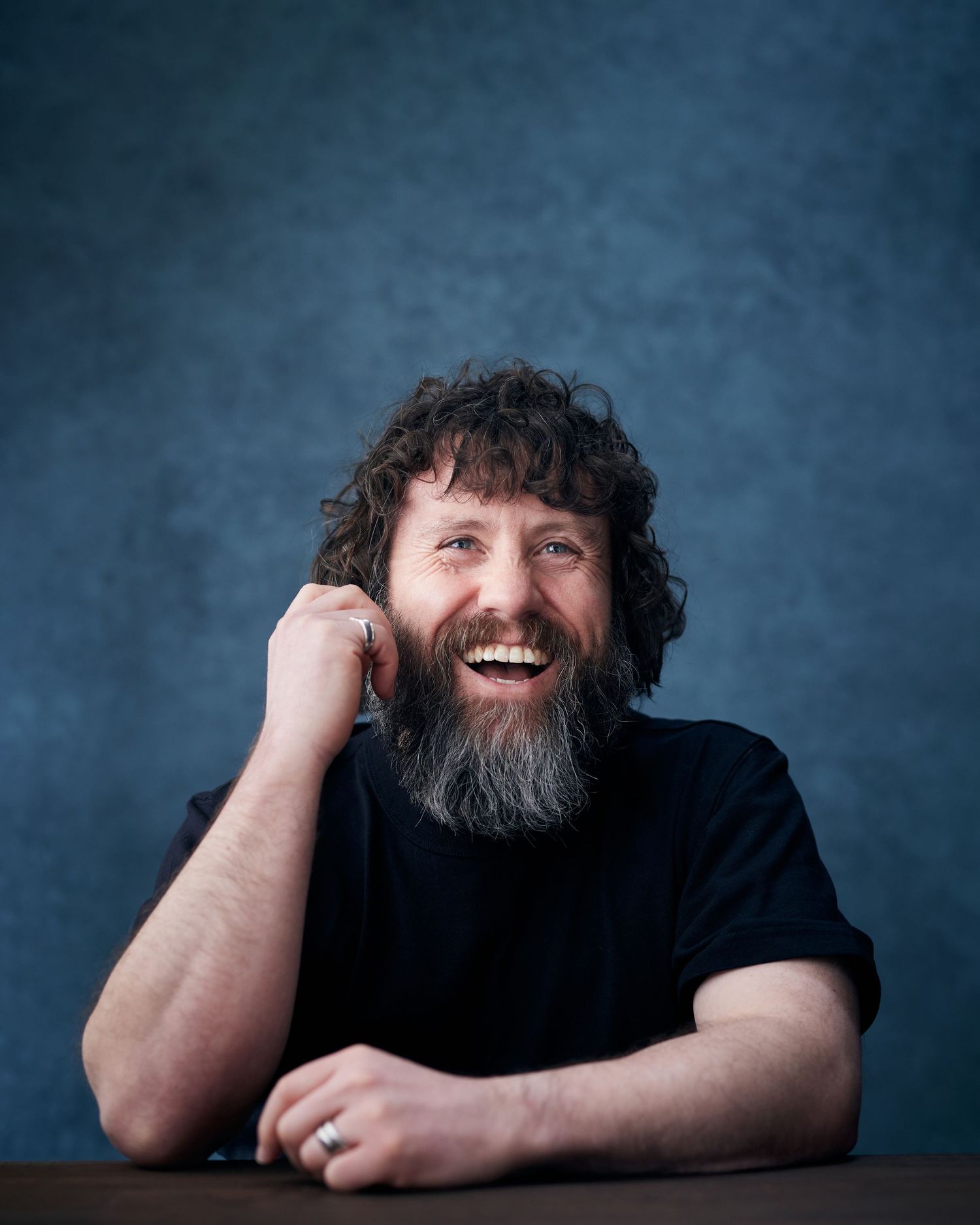 Laughter-filled portrait; man with a wide, joyful, and expressive smile.