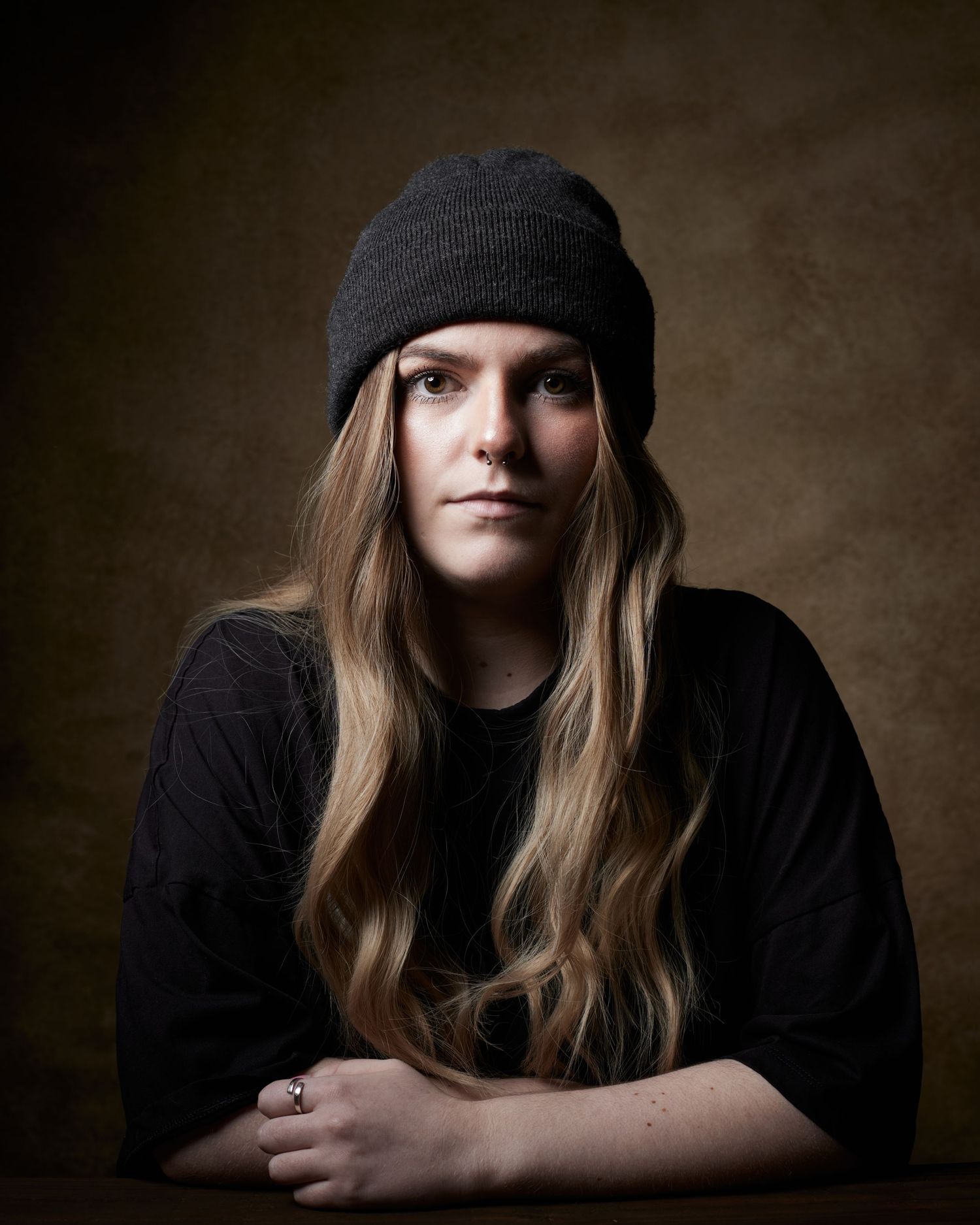 Bold studio headshot; actress with a steady, unblinking look for antagonist roles.