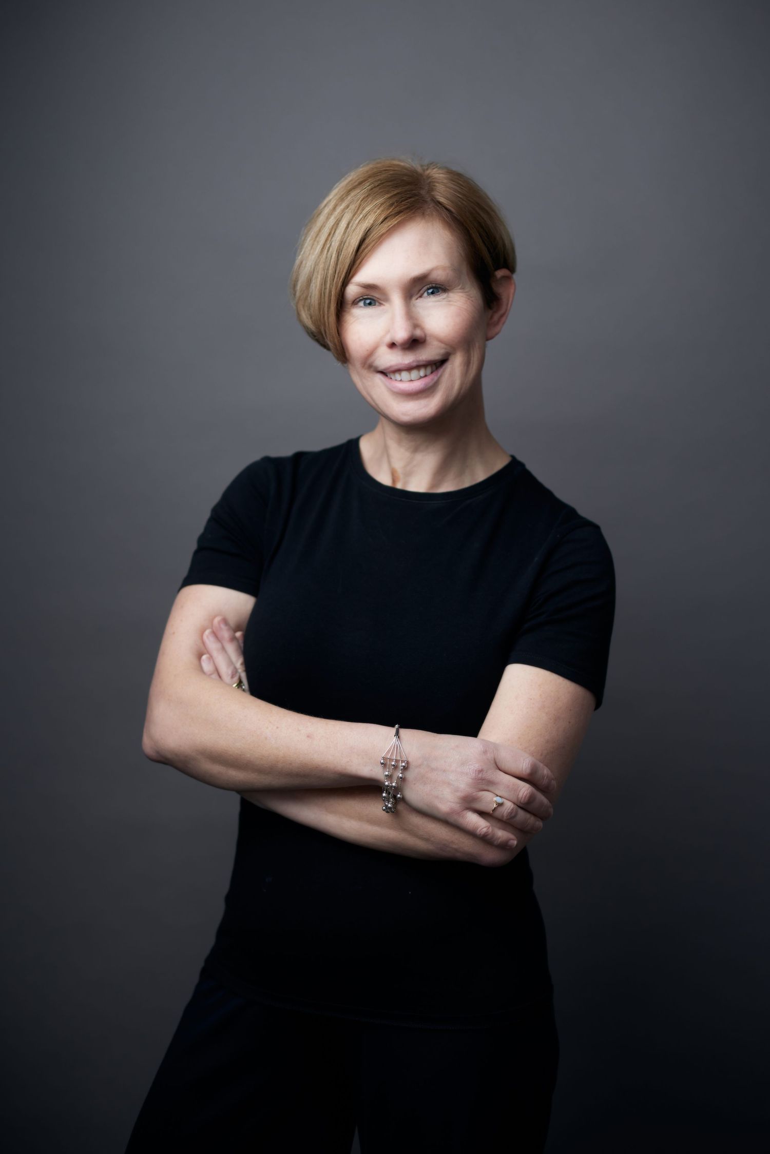 Empowered business portrait; professional woman with a steady, confident gaze by Geraint Todd in Cardiff.