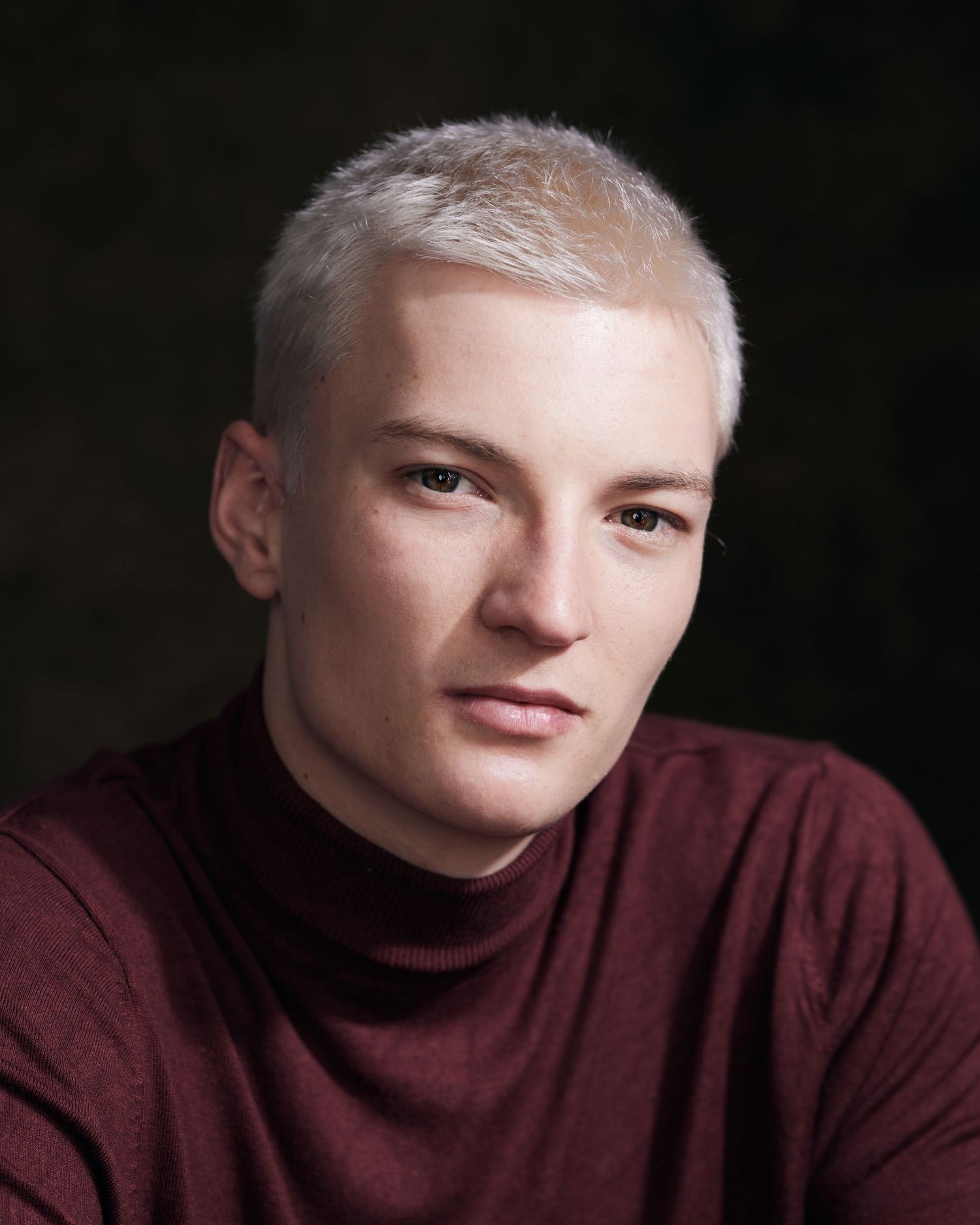 Gritty headshot; actor with a raw, emotional intensity and high-contrast lighting.