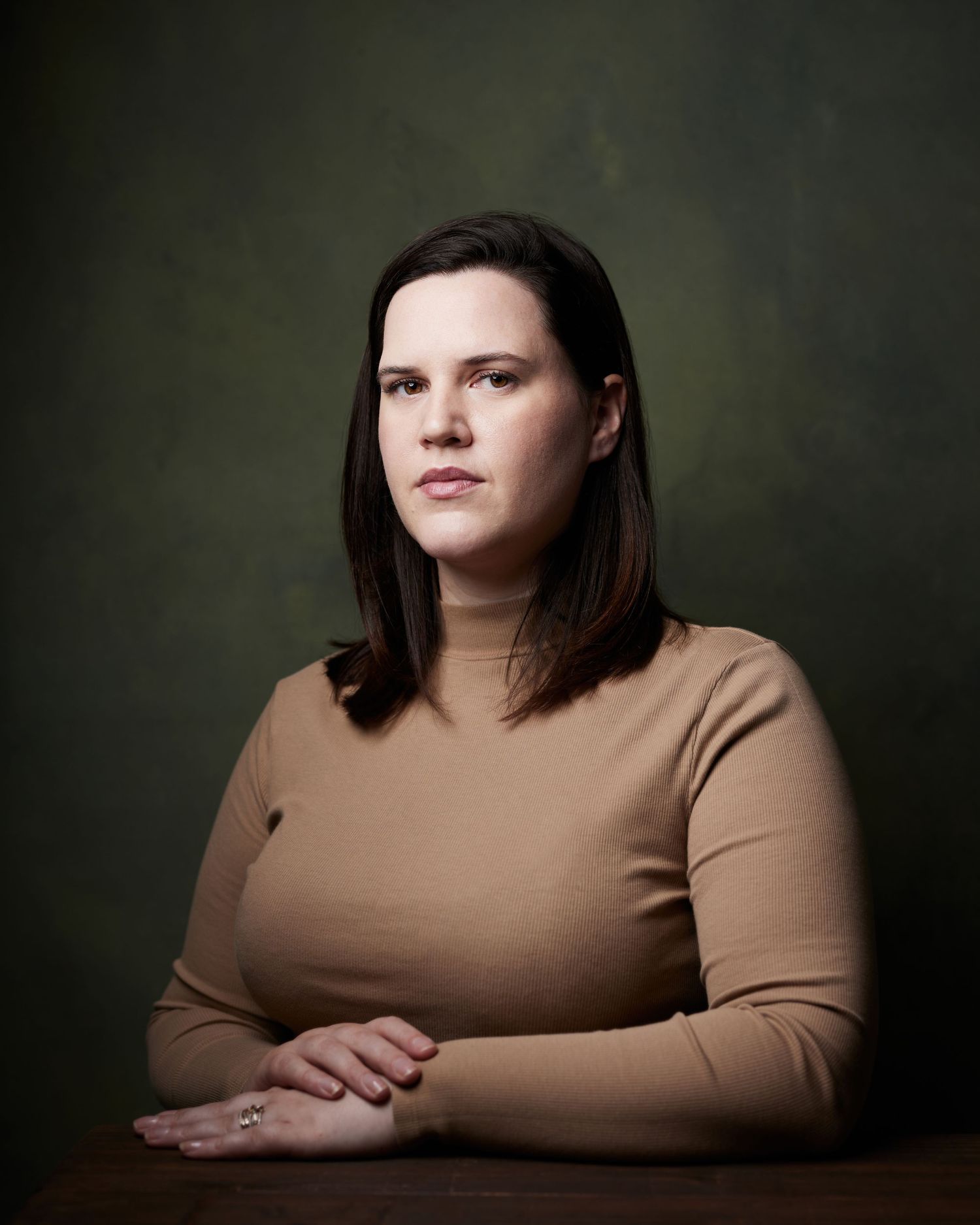 Strong character portrait; woman with a stern, authoritative presence in the studio.