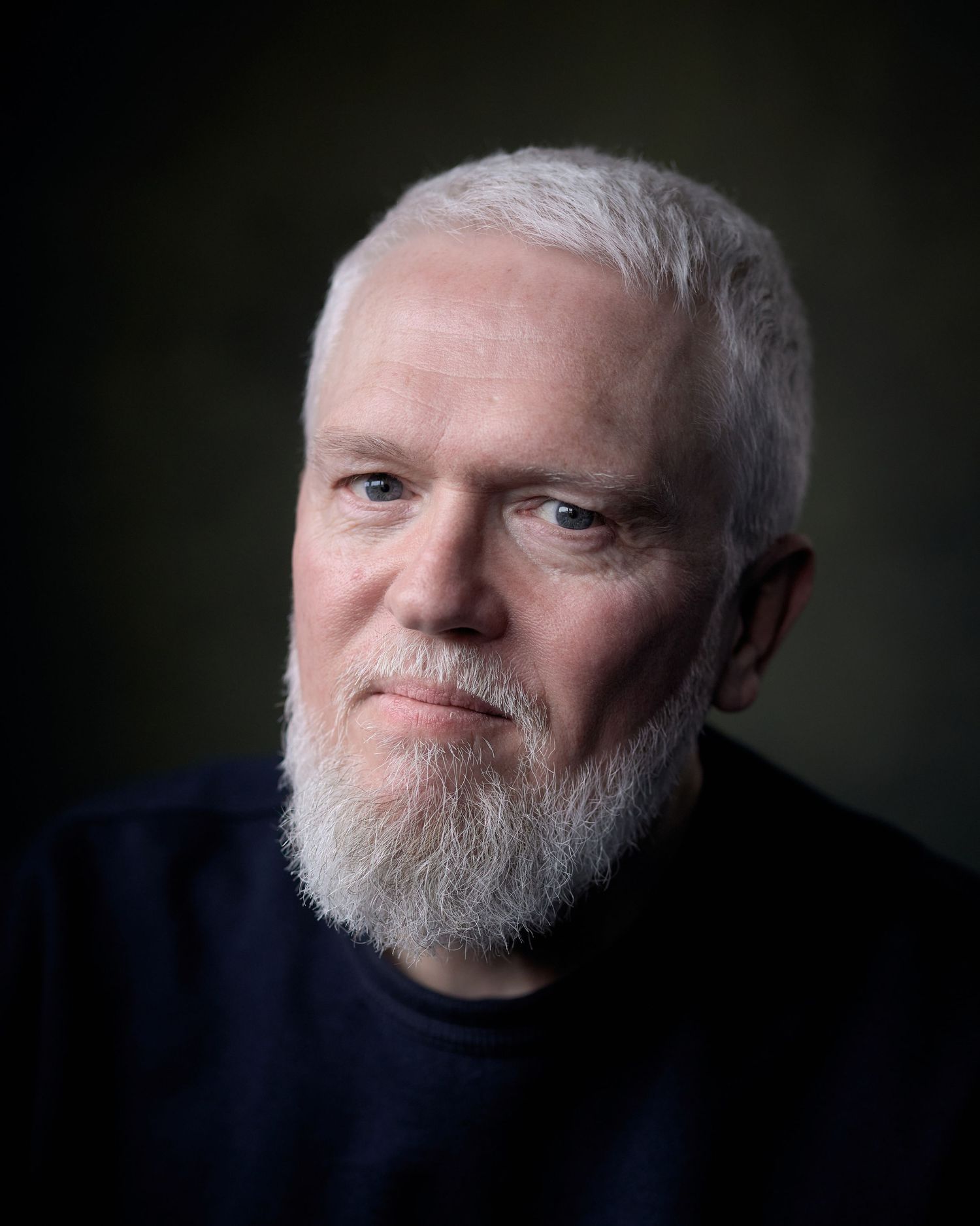 Professional headshot of actor Jeremi Cockram with a subtle, approachable expression and soft cinematic lighting in a Cardiff studio.