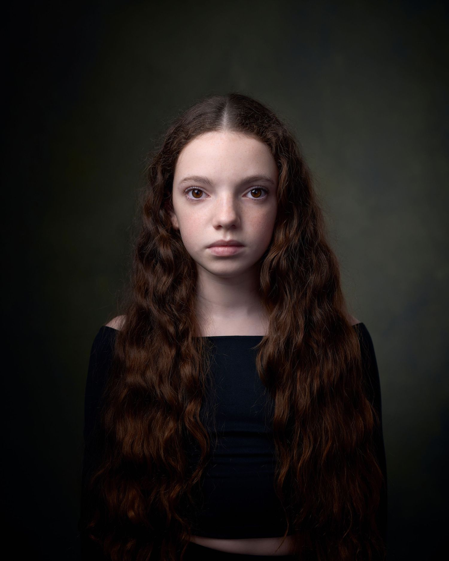 Child actor headshot by Geraint Todd. Direct gaze gaze against a textured dark green backdrop in a Cardiff studio.